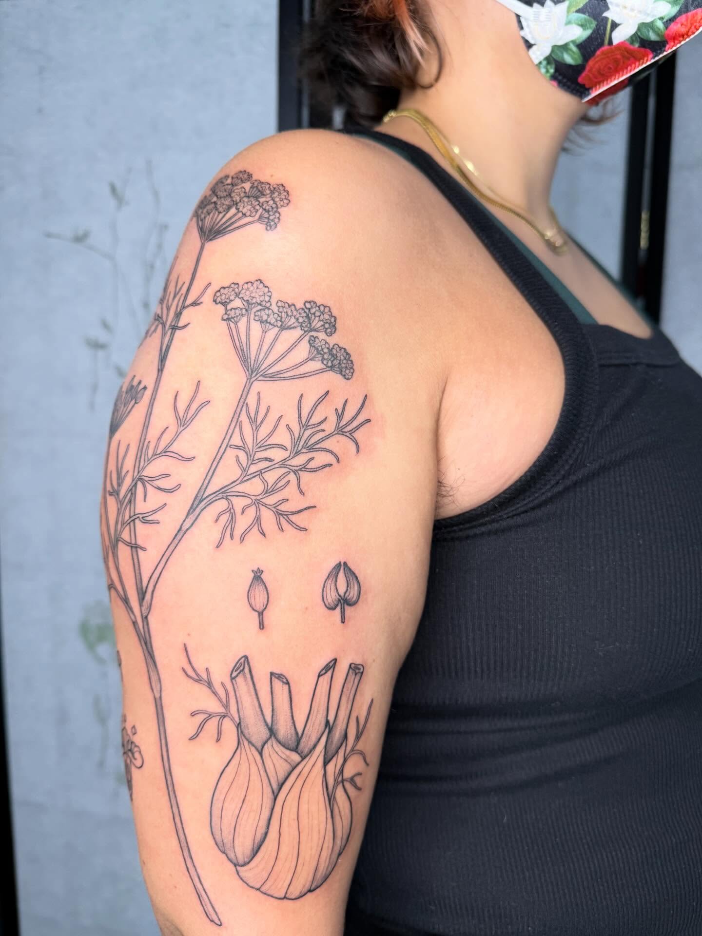 Herb plant black and grey tattoo on the shoulder by Noelle Adrienne Tattoos