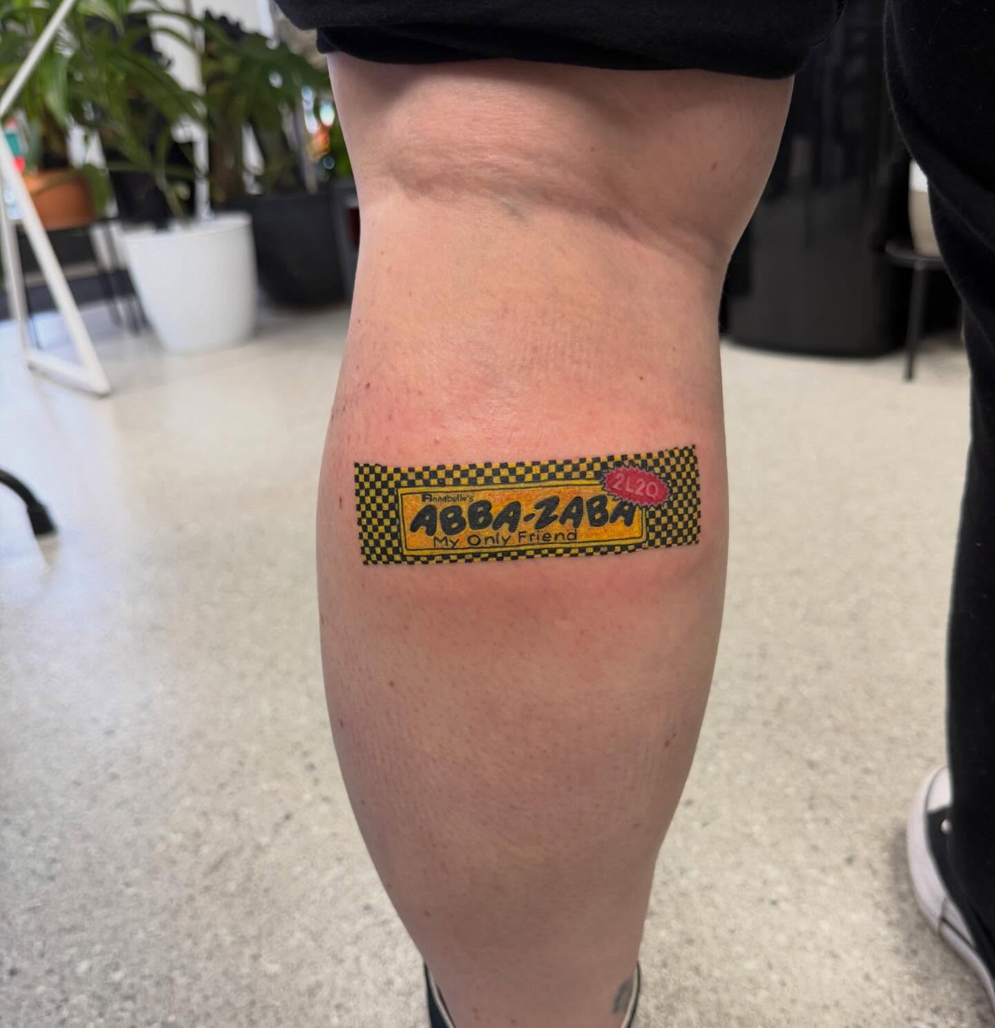 Abba-Zaba trash polka tattoo on the calf by Aura Noire