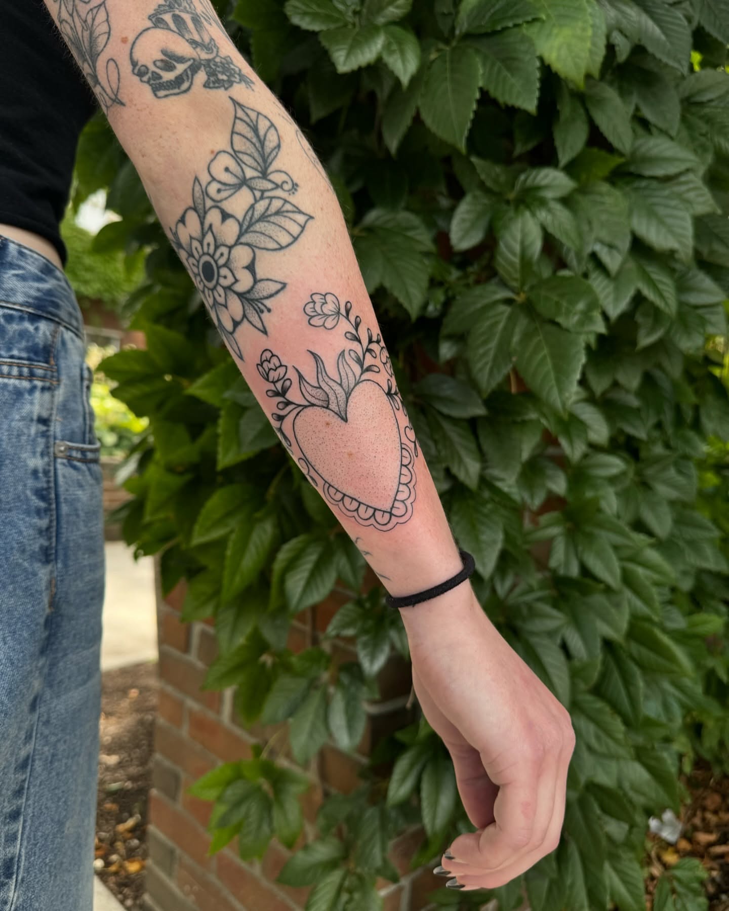 Heart with floral elements black and grey tattoo on the forearm by ꧁꧁Hayley꧂꧂