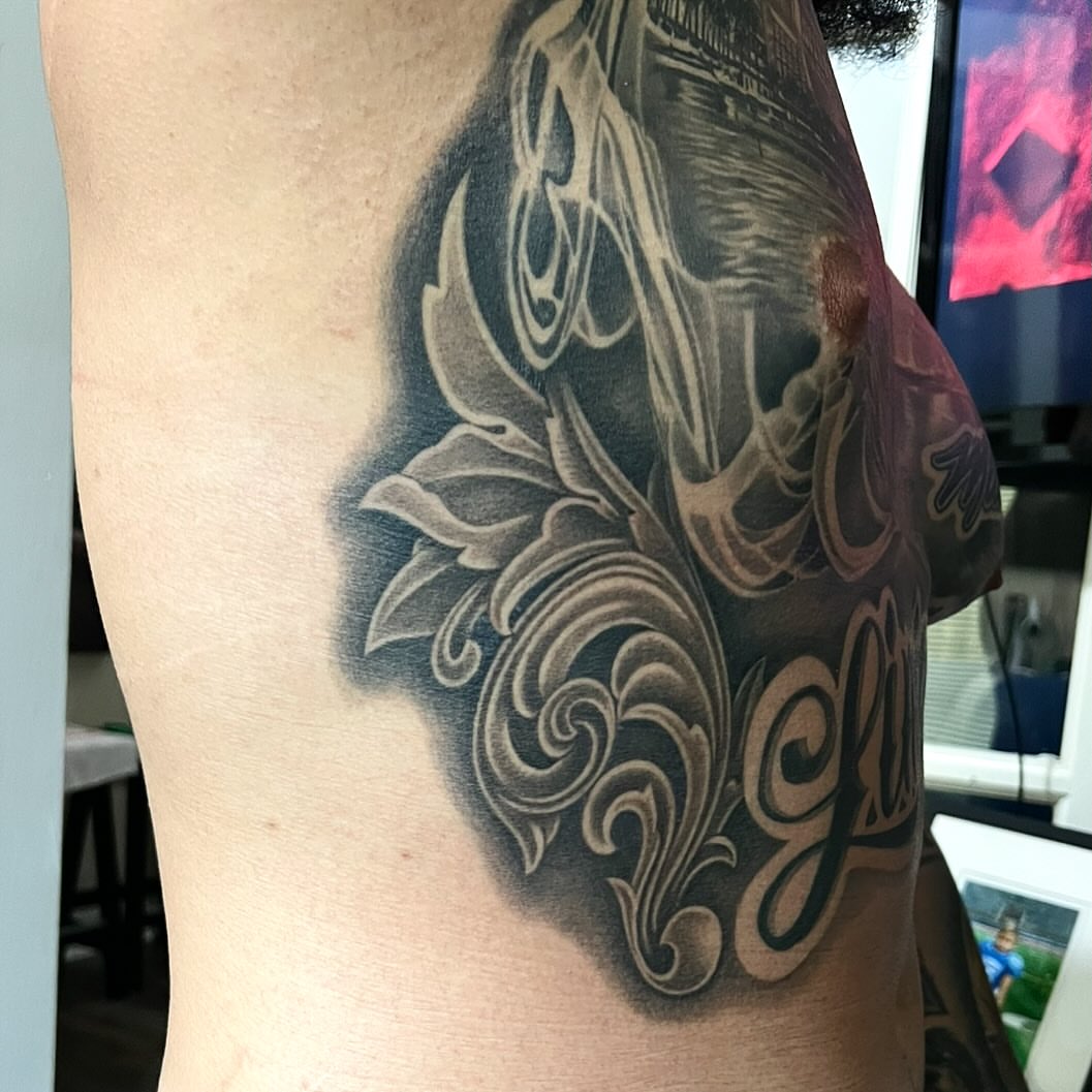 Scrollwork ornamental tattoo on the thigh by Jay