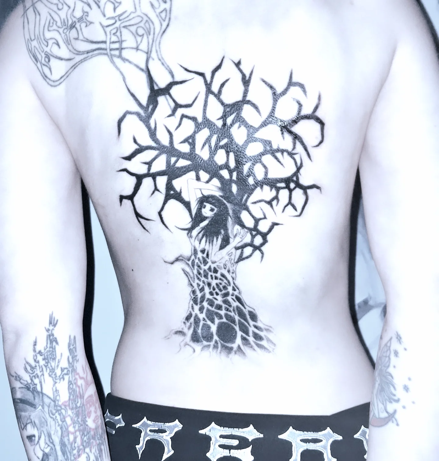 Tree with woman dark realism tattoo on the back by hallowed girl tattoo