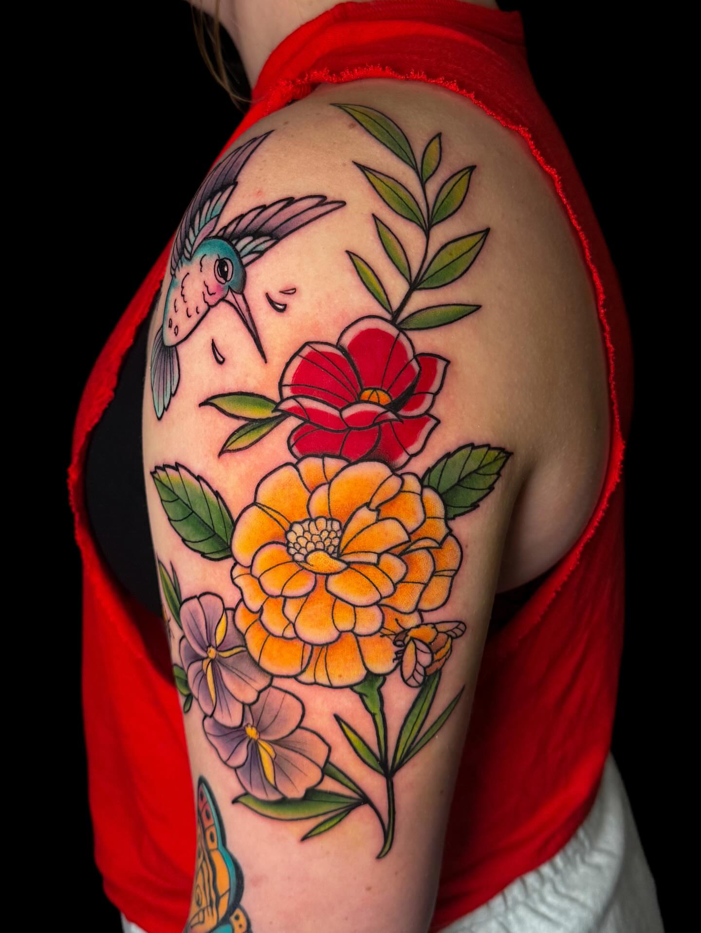 Hummingbird and flowers American traditional tattoo on the shoulder by Demi DiMartino