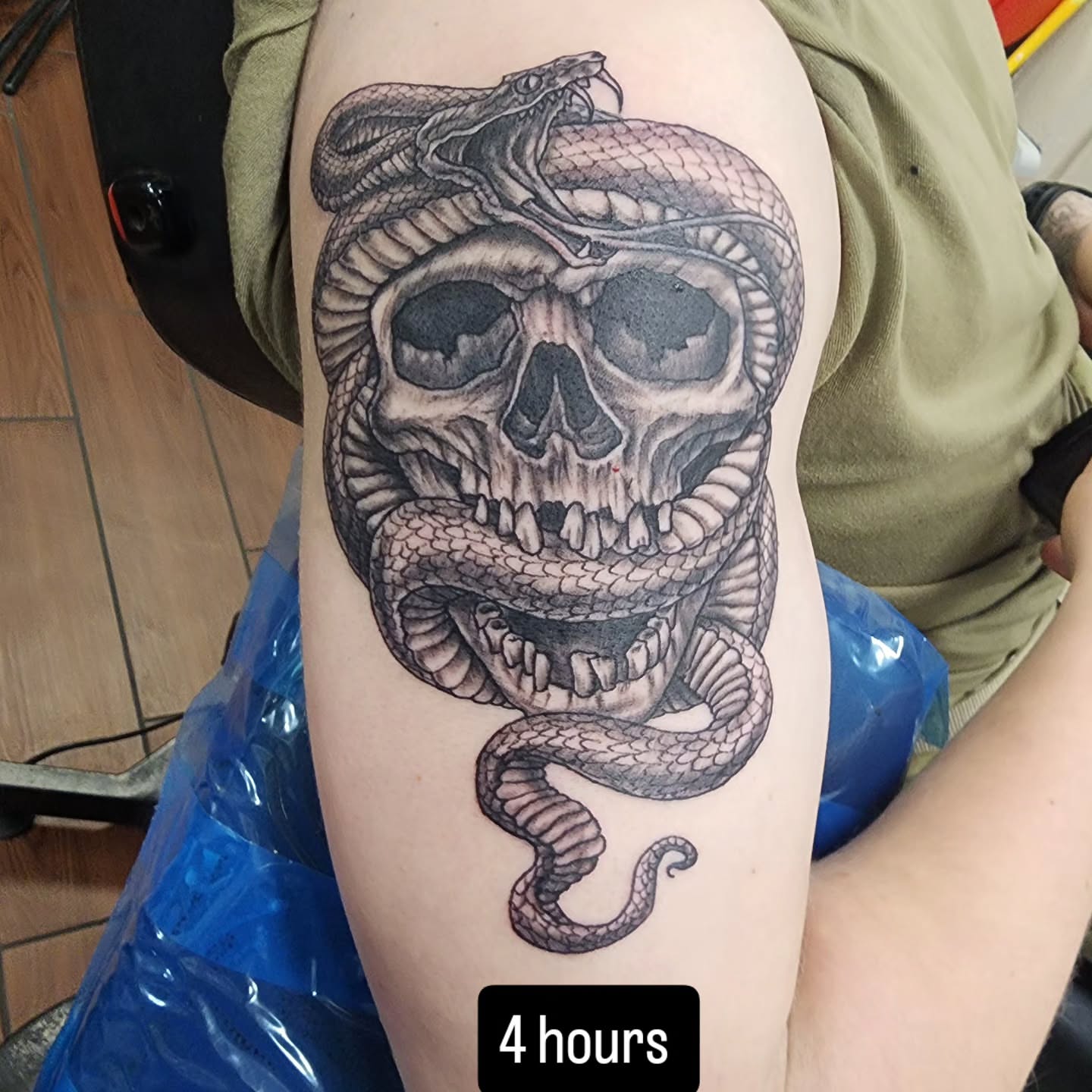 Snake and skull realism tattoo on the forearm by Jeff Frederick