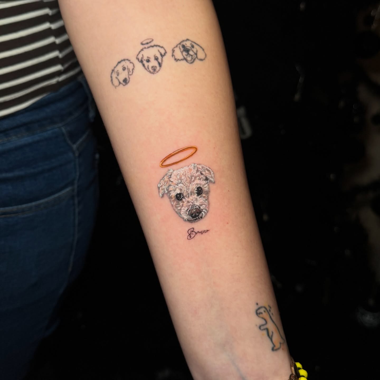 Dog with halo realism tattoo on the forearm by Mishel Castro