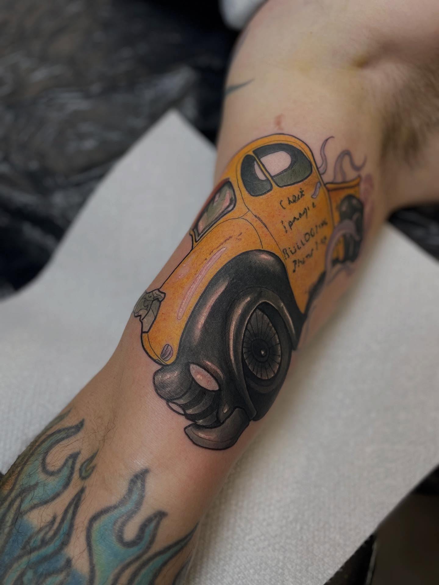 Yellow car American traditional tattoo on the forearm by Nathan Evans