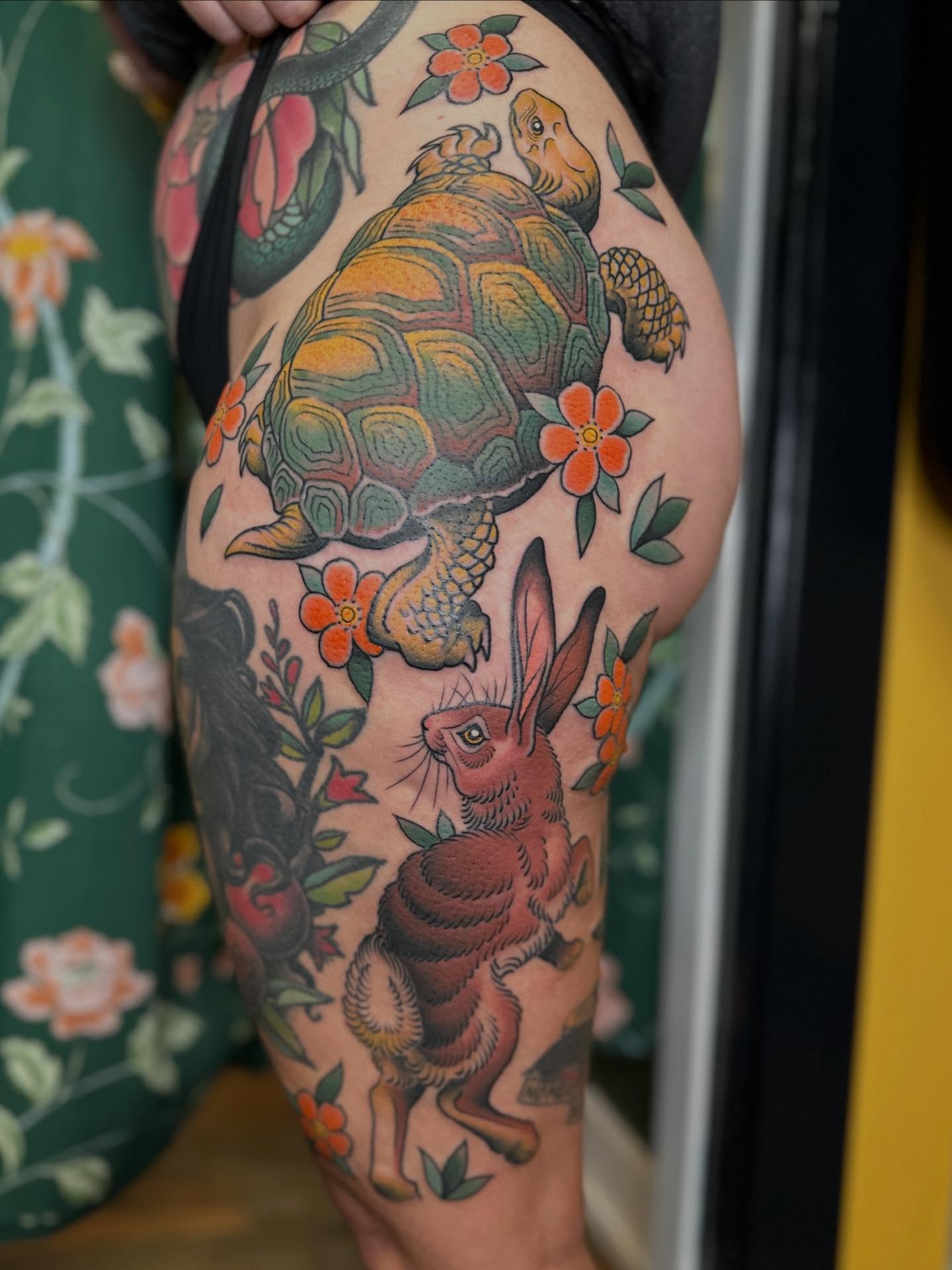 Turtle and rabbit American traditional tattoo on the thigh by Megon Shore, Seattle, Washington