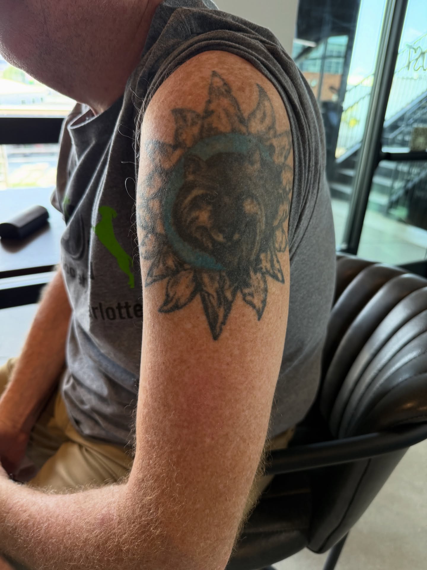 Sun and moon black and grey tattoo on the upper arm by Absolute