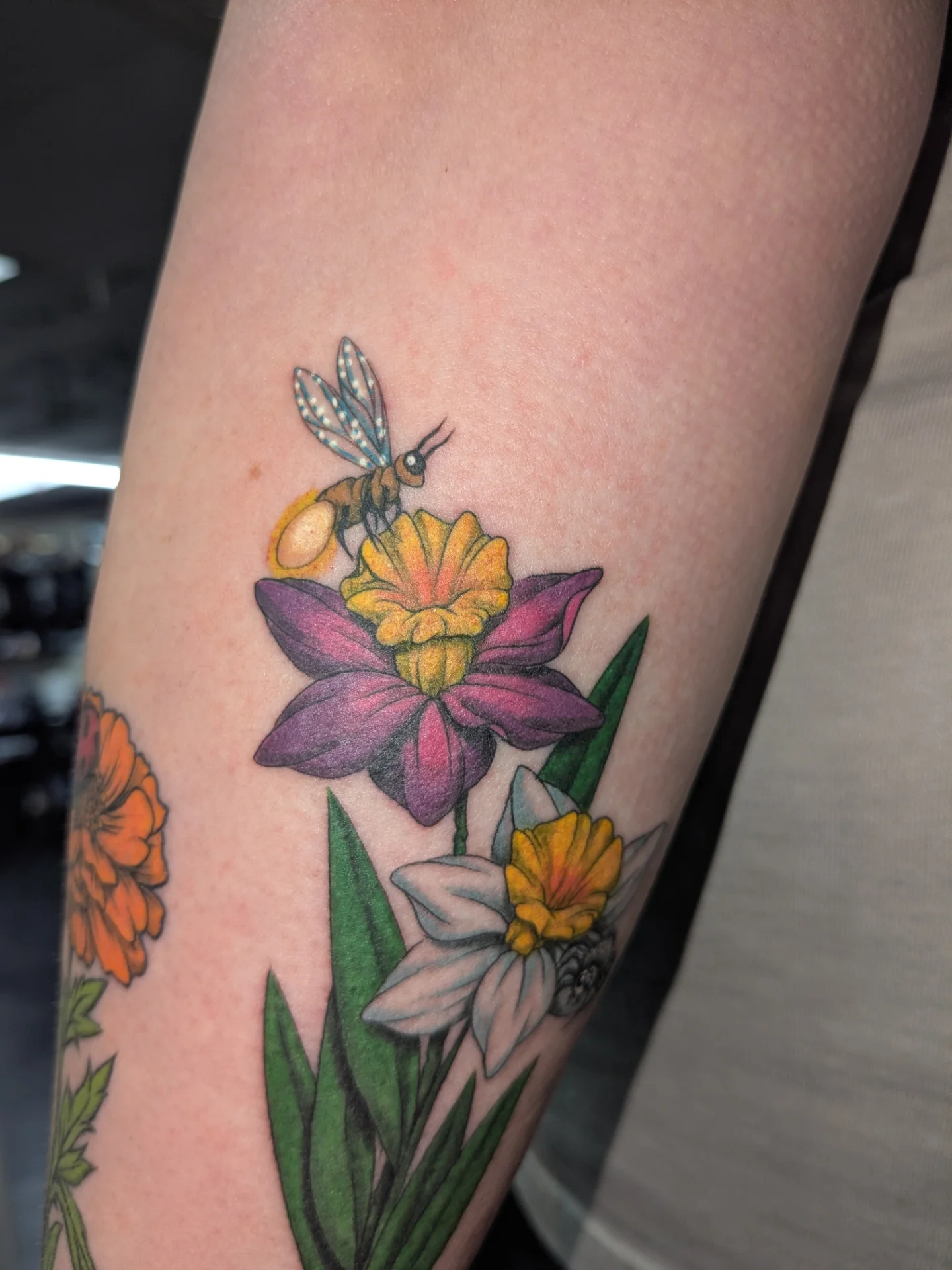 Flowers and bee realism tattoo on the forearm by Jessica Thomas Fleischman, Morganton, North Carolina