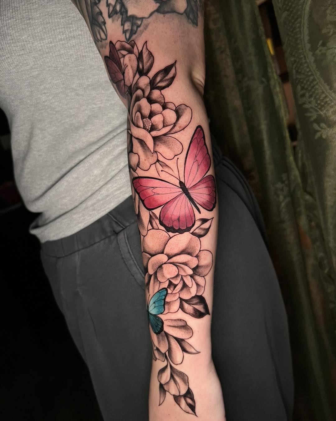 Butterfly and flowers new school tattoo on the forearm by Mikaela Rush, Greensboro, North Carolina