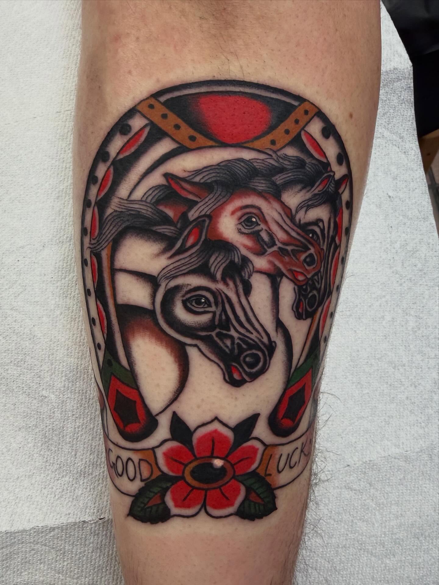 Horses and flower American traditional tattoo on the forearm by David Evans