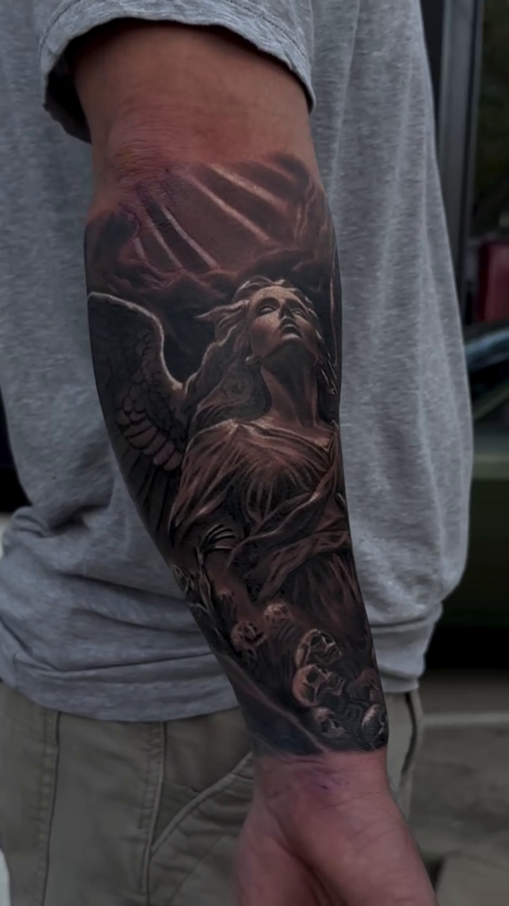 Angelic figure with wings realism tattoo by Michael Sosa