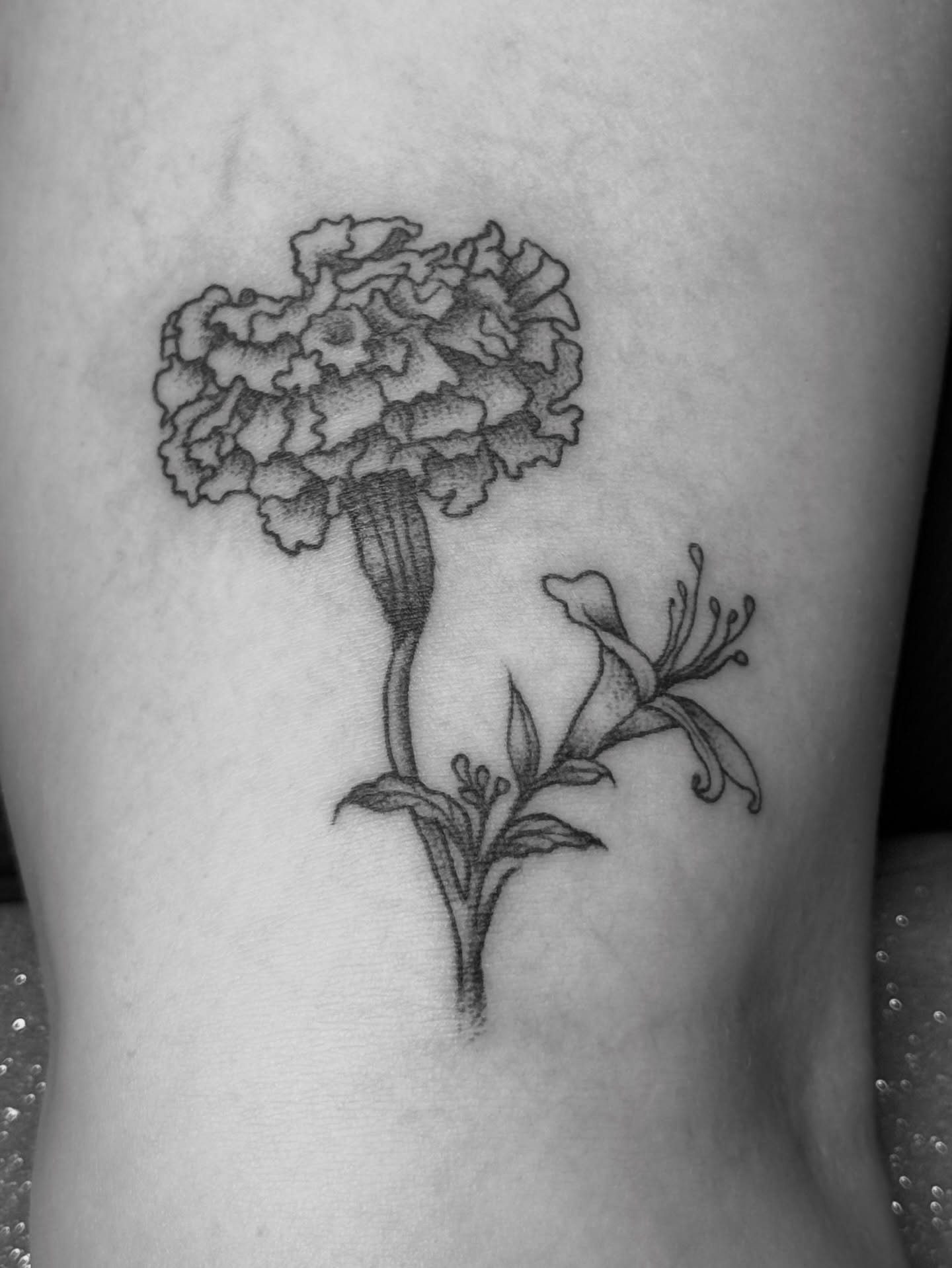 Marigold black and grey tattoo on the thigh by Bronzino Ink - Karen, Asheville, North Carolina