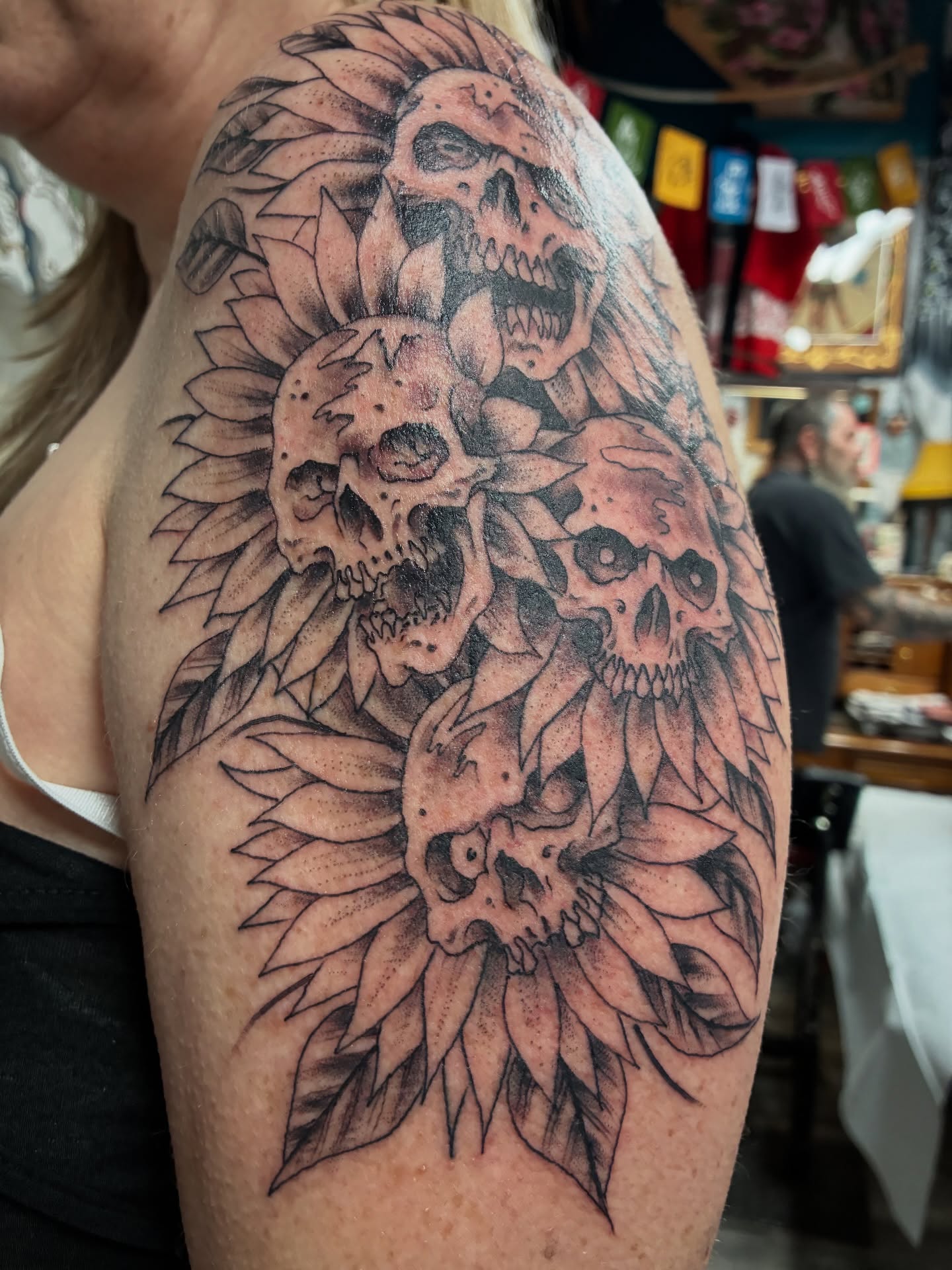 Skulls and feathers realism tattoo on the shoulder by Kennedy Cole