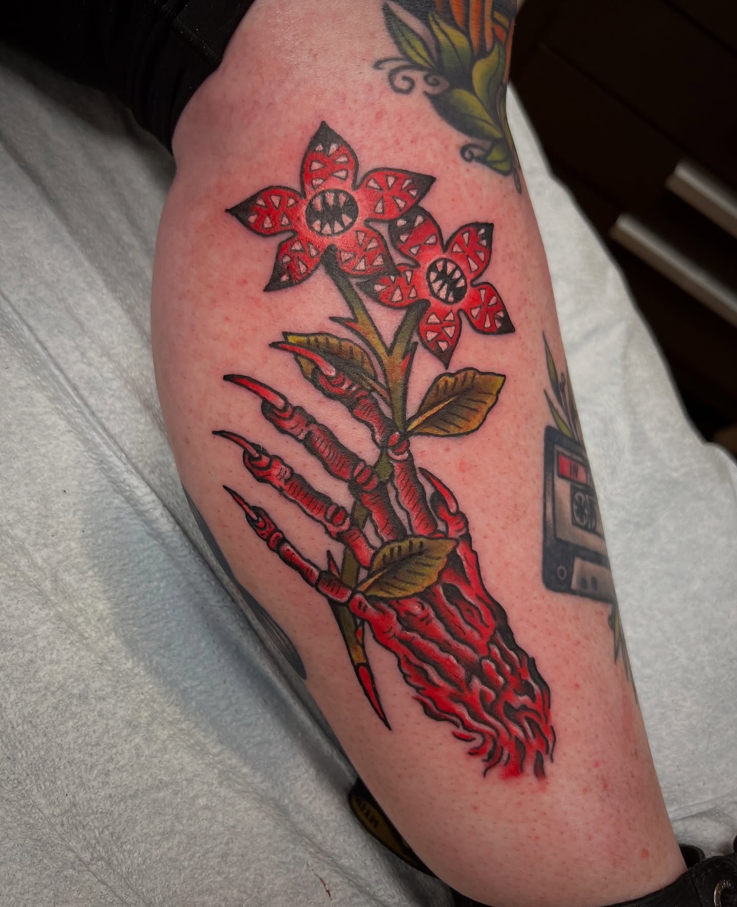 Flower with claw hand American traditional tattoo on the forearm by Shannon Pagliarini