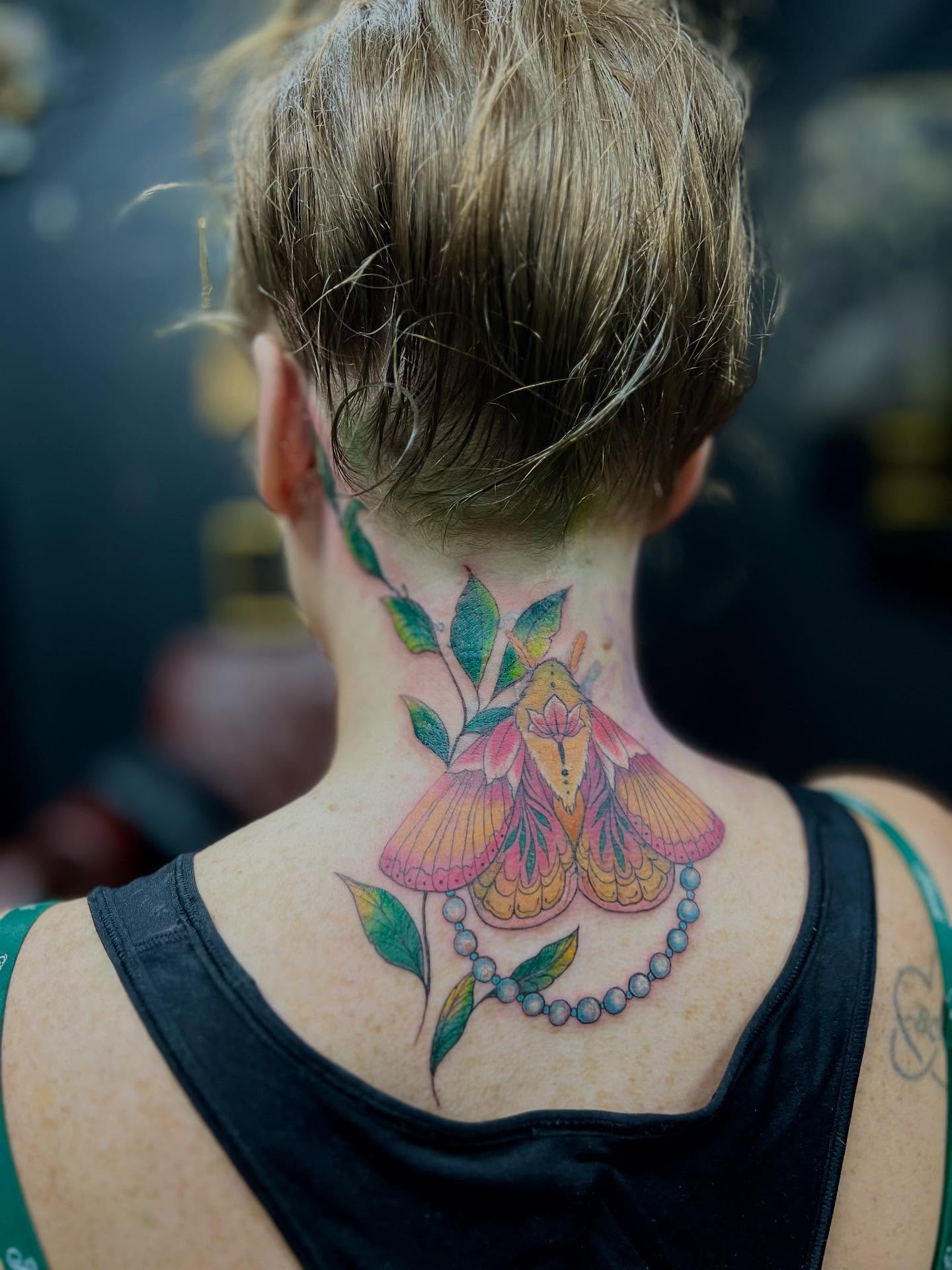 Butterfly and floral new school tattoo on the back by Rebecca Kern Tattoos