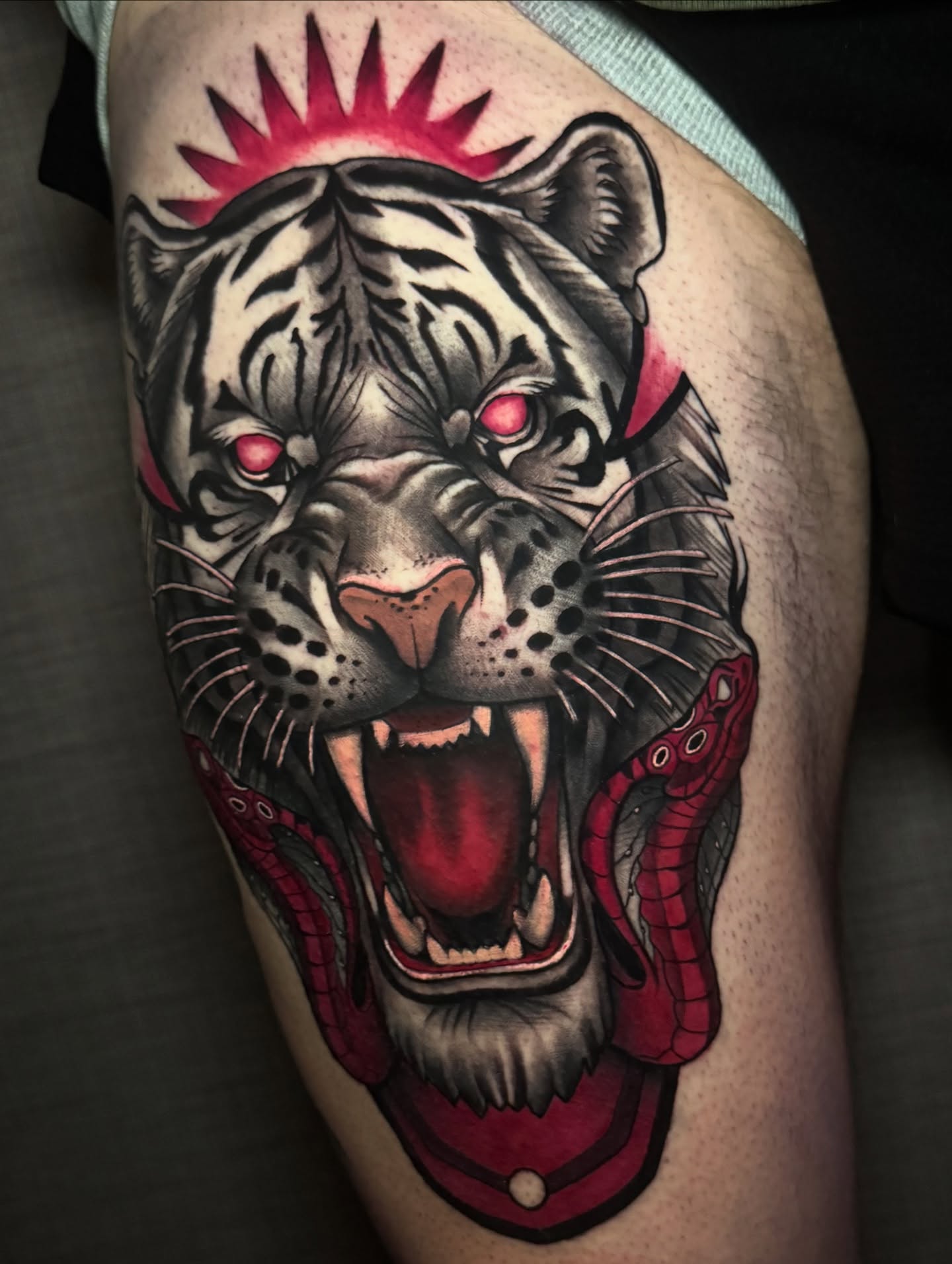 Tiger American traditional tattoo on the thigh by Jaxx Kesler