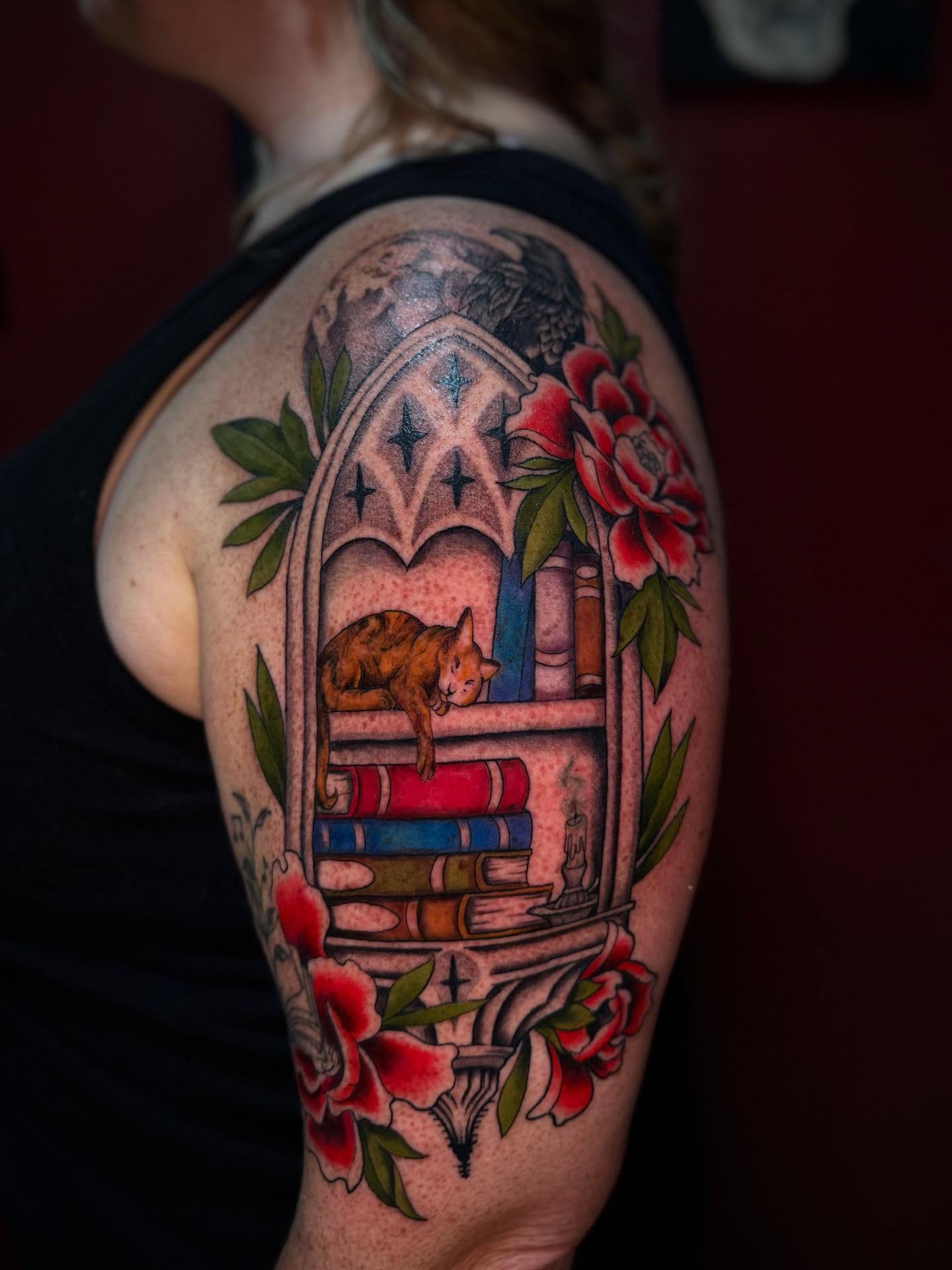 Cat and bookshelf American traditional tattoo on the shoulder by Penny - Tattooer