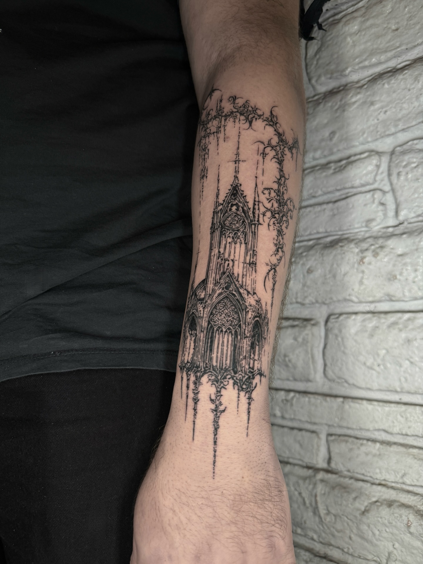 Gothic cathedral realism tattoo on the forearm by Cybersigilism & Fineline Blackwork