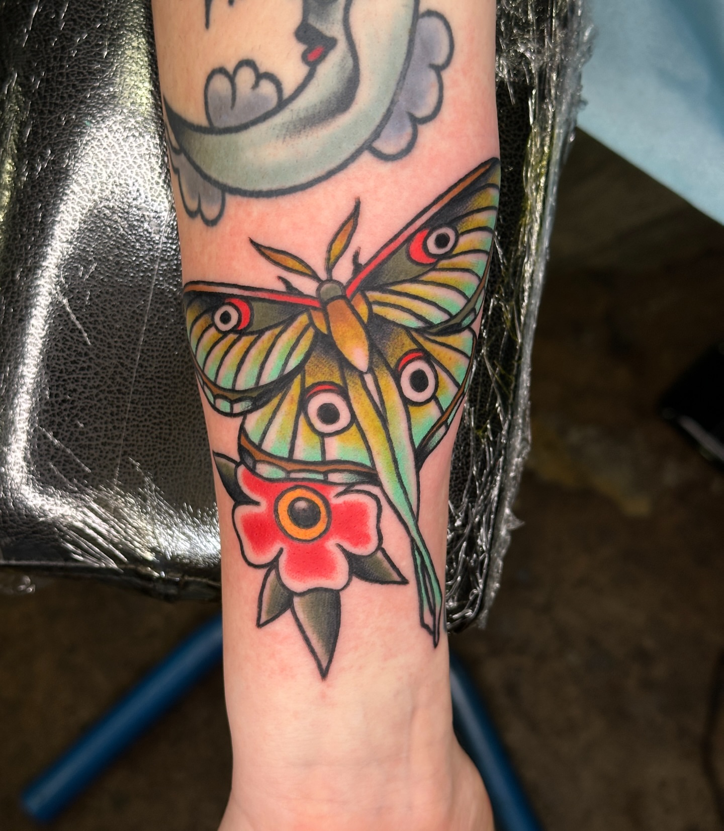 Butterfly and flower American traditional tattoo on the forearm by Jared, Addison, Texas
