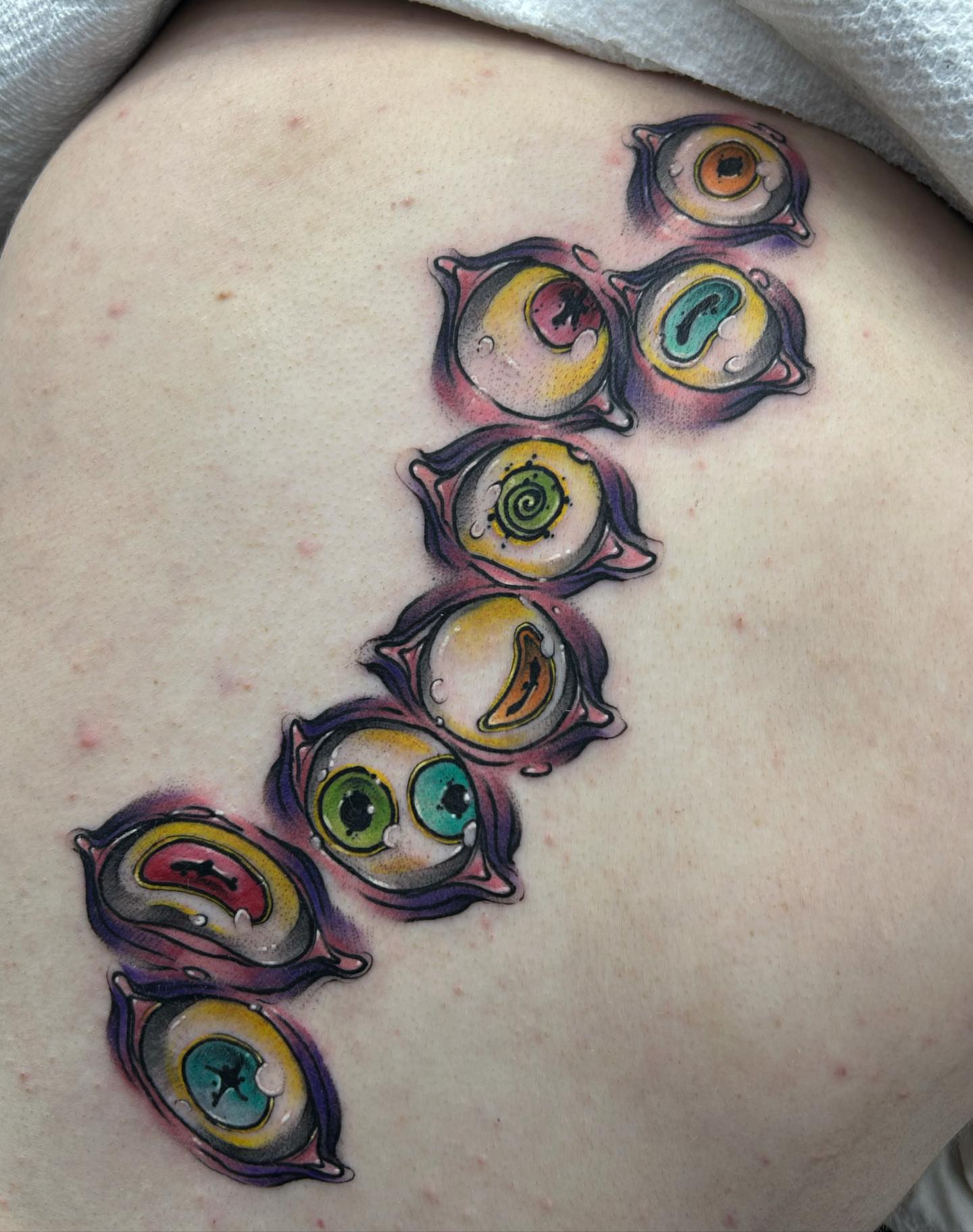 Eyes new school tattoo on the back by Tatijana., Kettering, Ohio