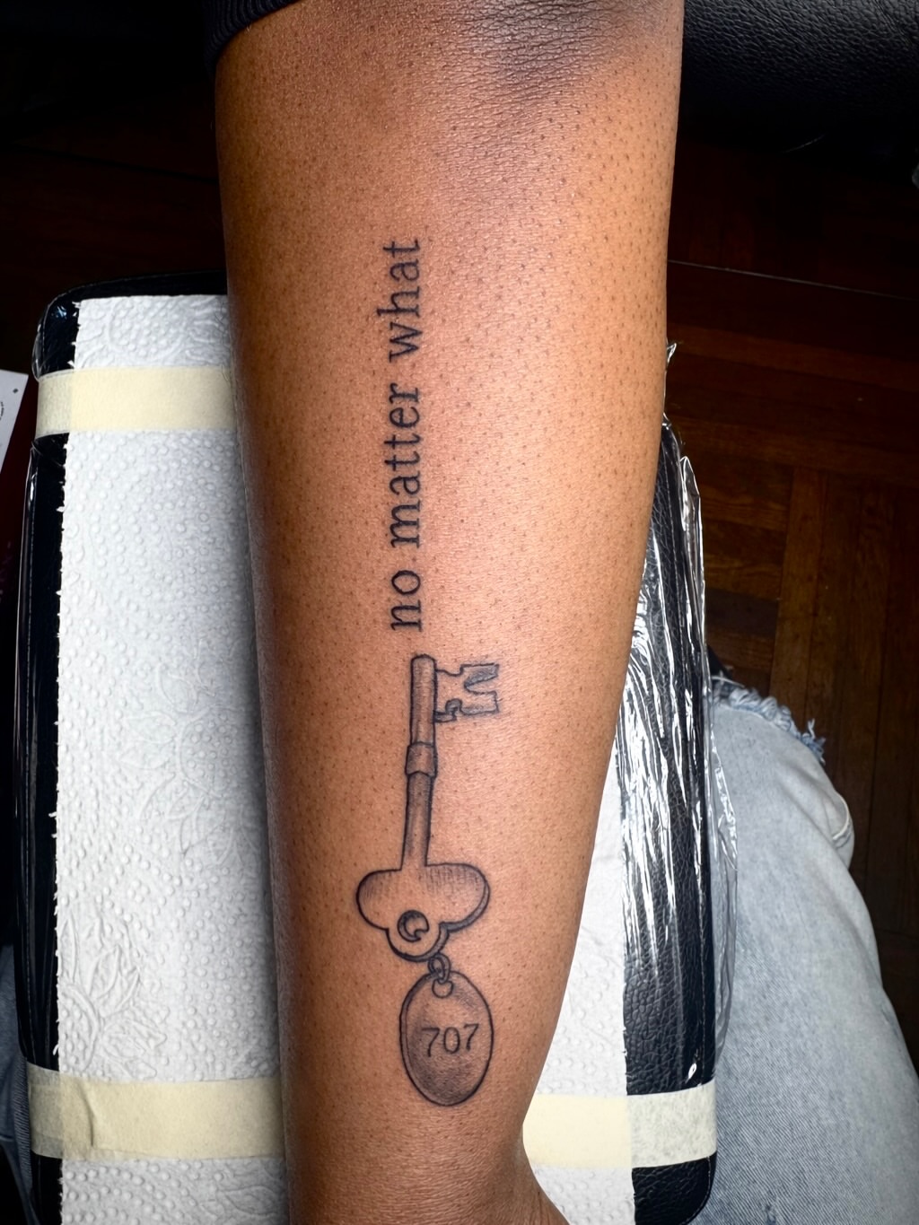 Key with number black and grey tattoo on the forearm by JayyeSosa