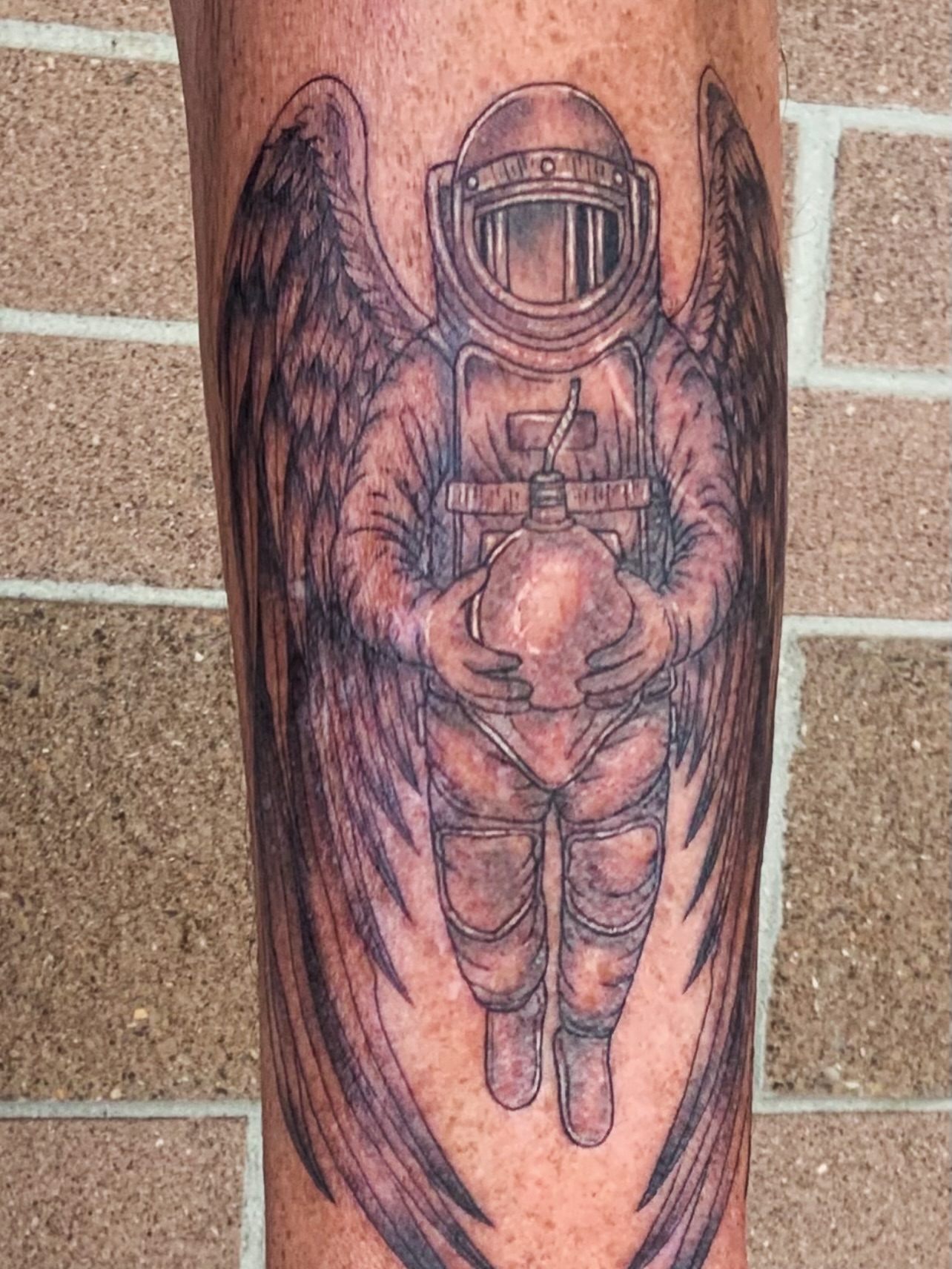 Astronaut with wings realism tattoo on the forearm by QUEEN TATTOO Stephanie Larson