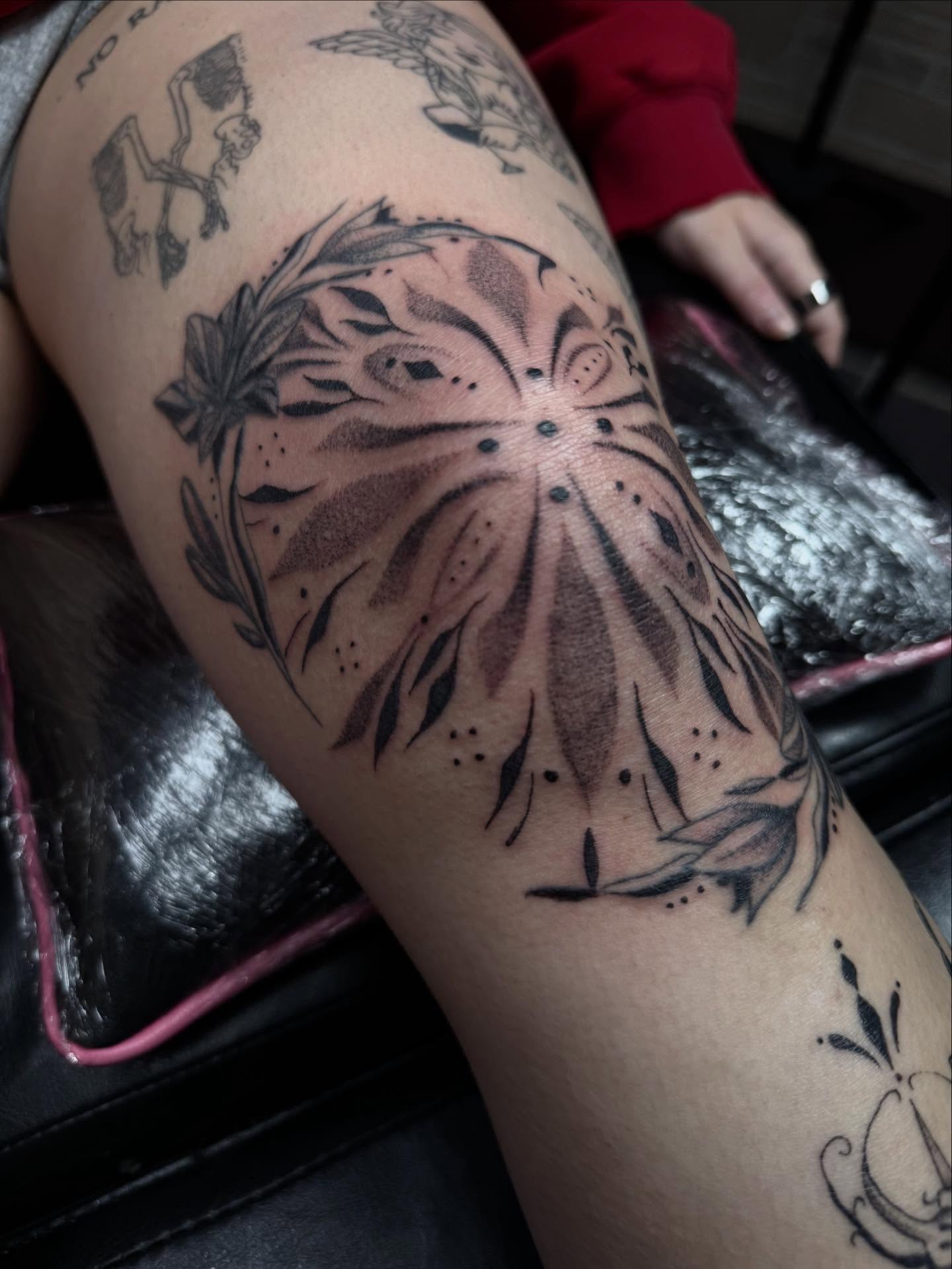 Sunflower dotwork tattoo on the thigh by olivia reed