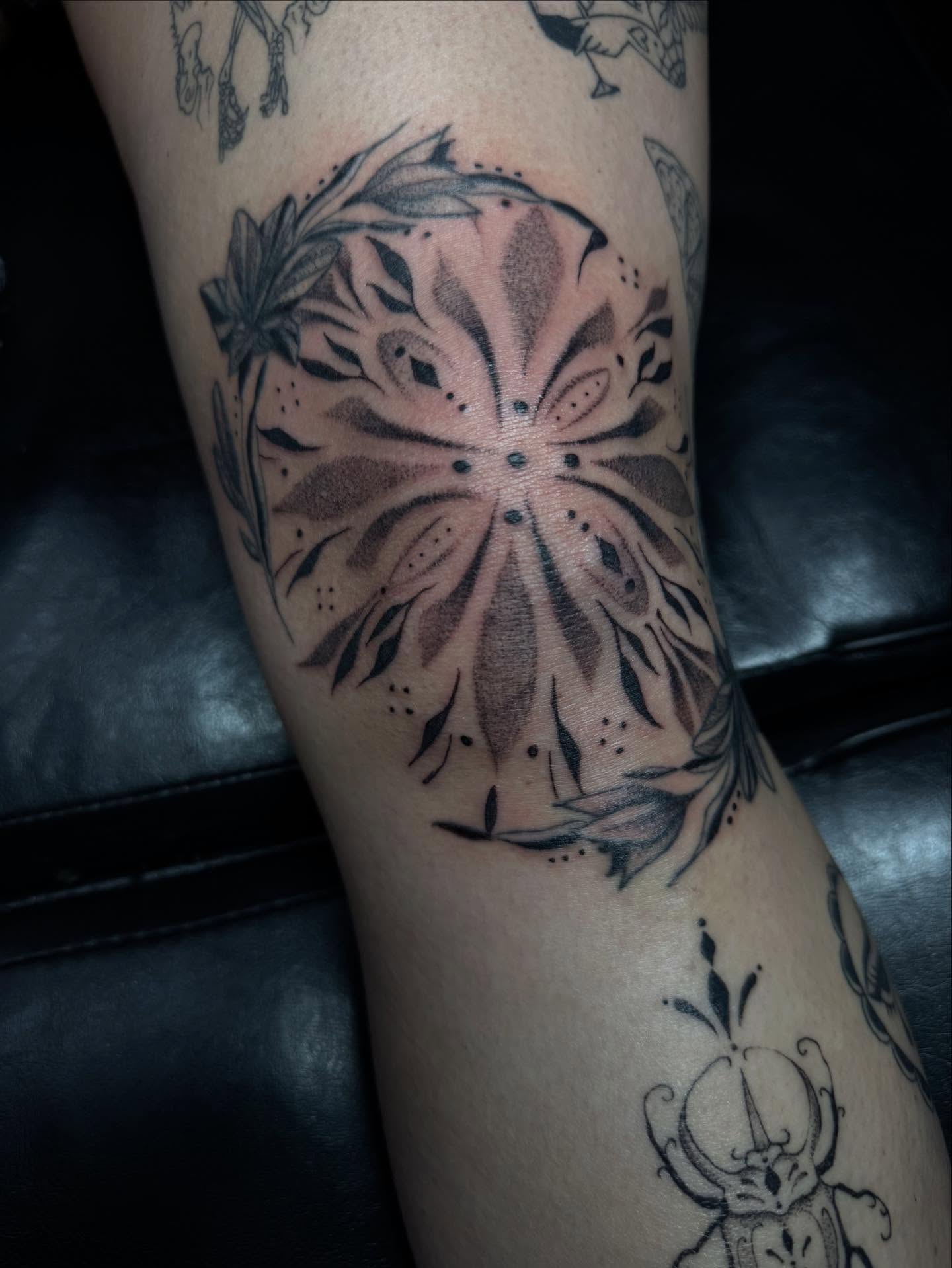 Geometric mandala dotwork tattoo on the forearm by olivia reed
