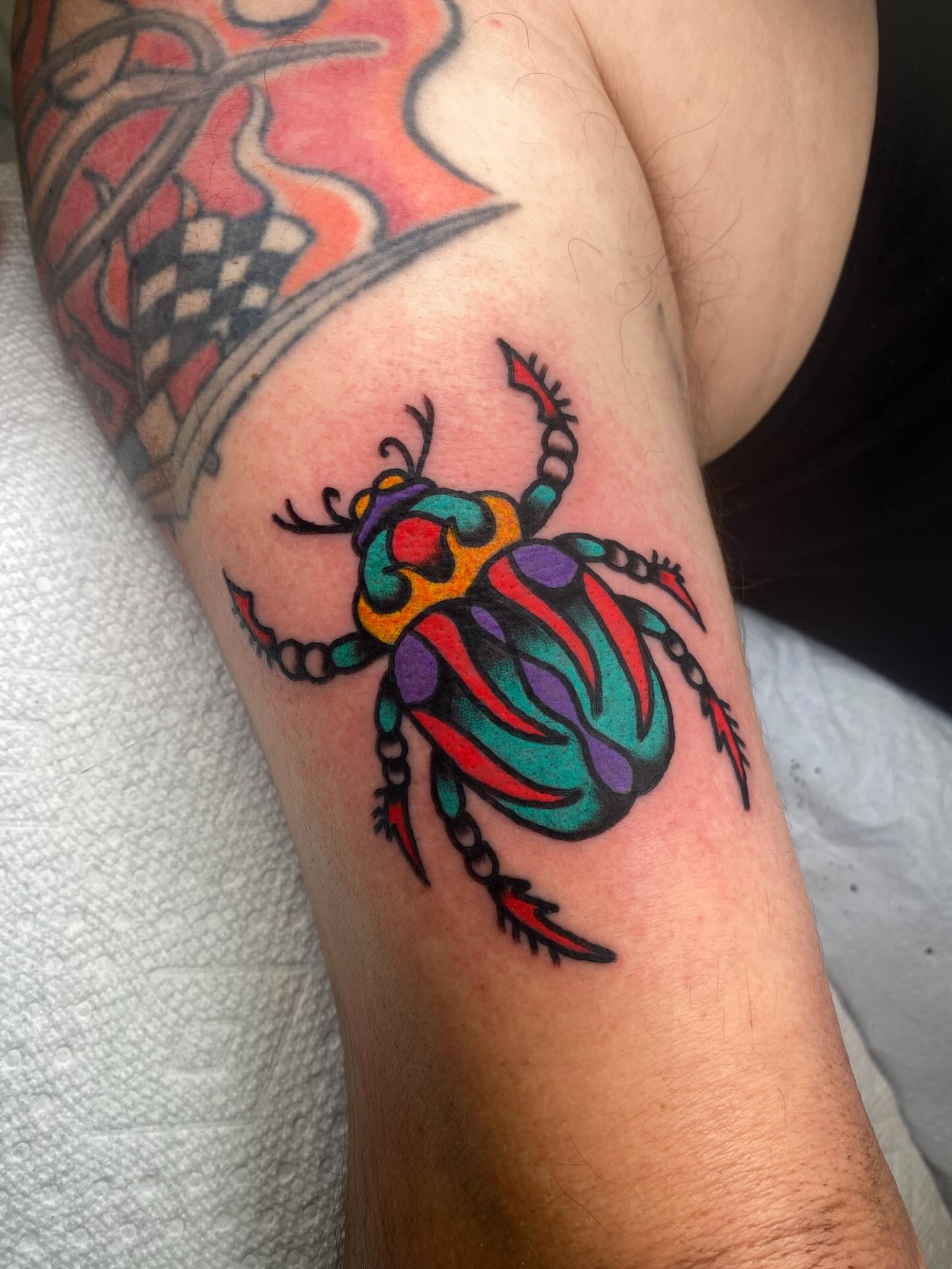 Beetle American traditional tattoo on the forearm by @rubber_band_dan, San Francisco, California