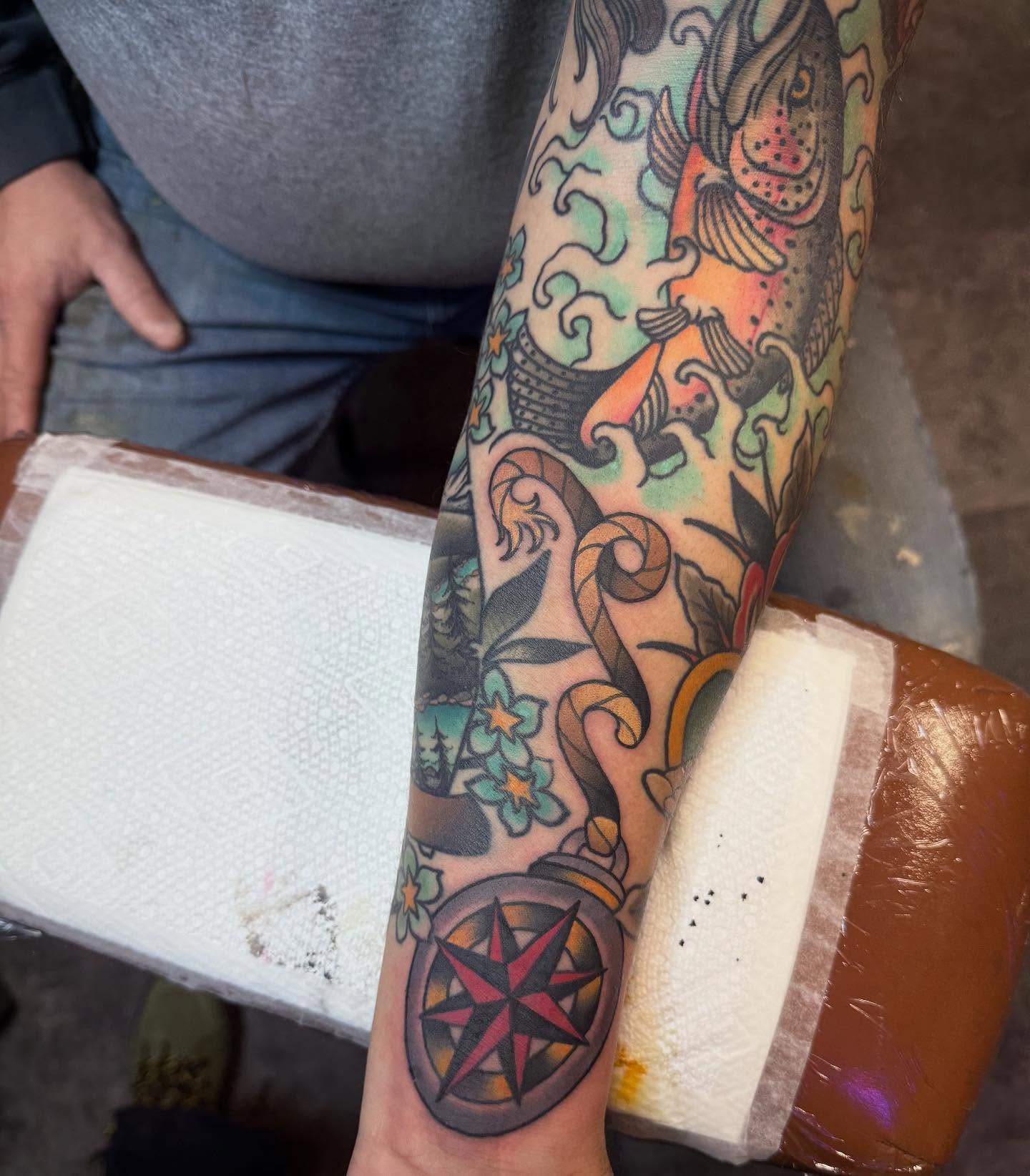 Fish and compass American traditional tattoo on the forearm by Jason Lawyer
