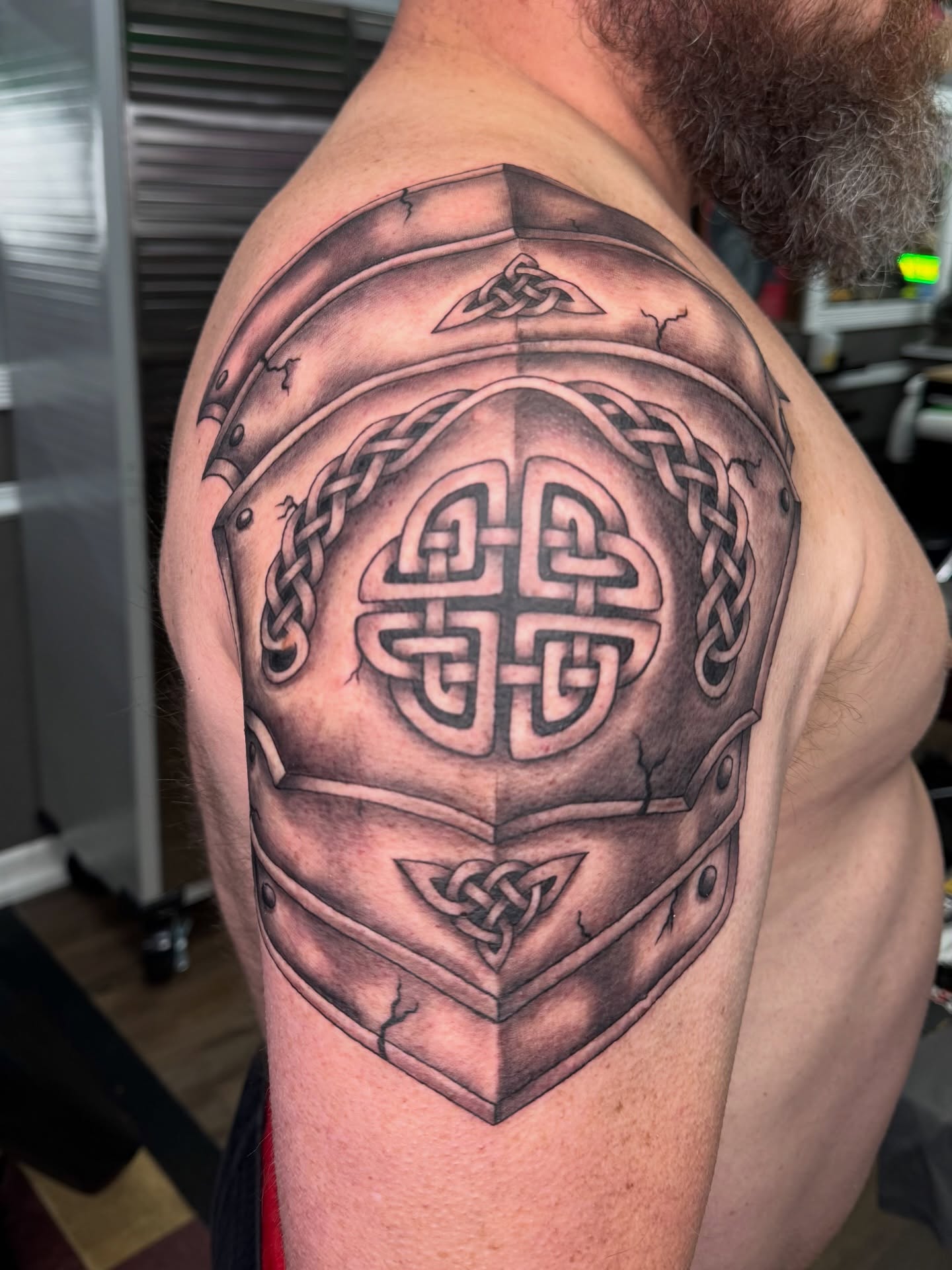 Helmet geometric tattoo on the shoulder by Cora Phelps