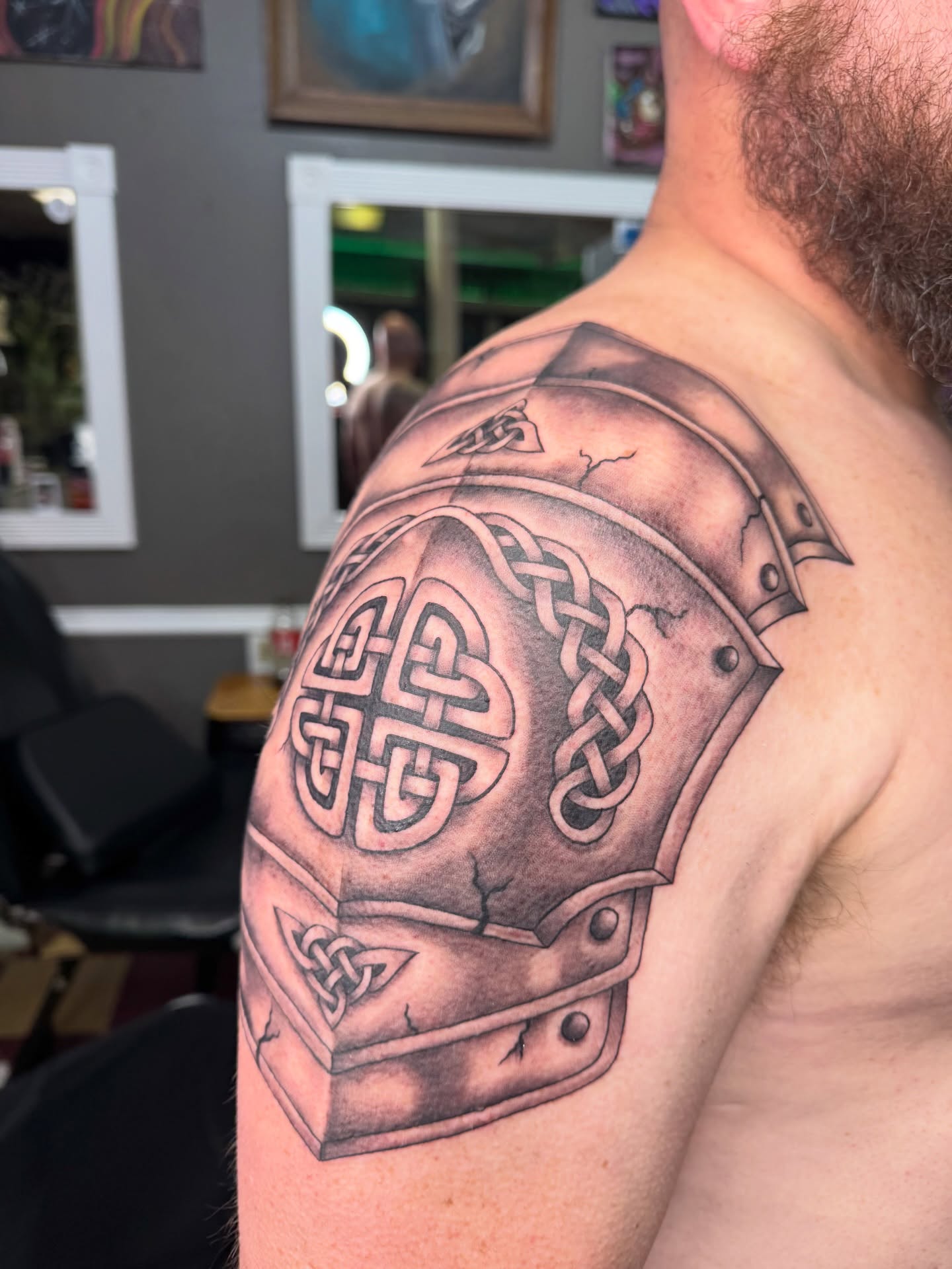 Helmet and knotwork realism tattoo on the shoulder by Cora Phelps