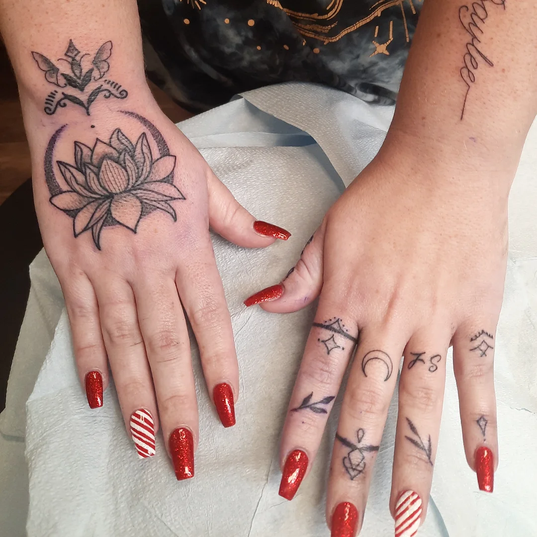 Lotus flower American traditional tattoo on the hand by Kaetlyn