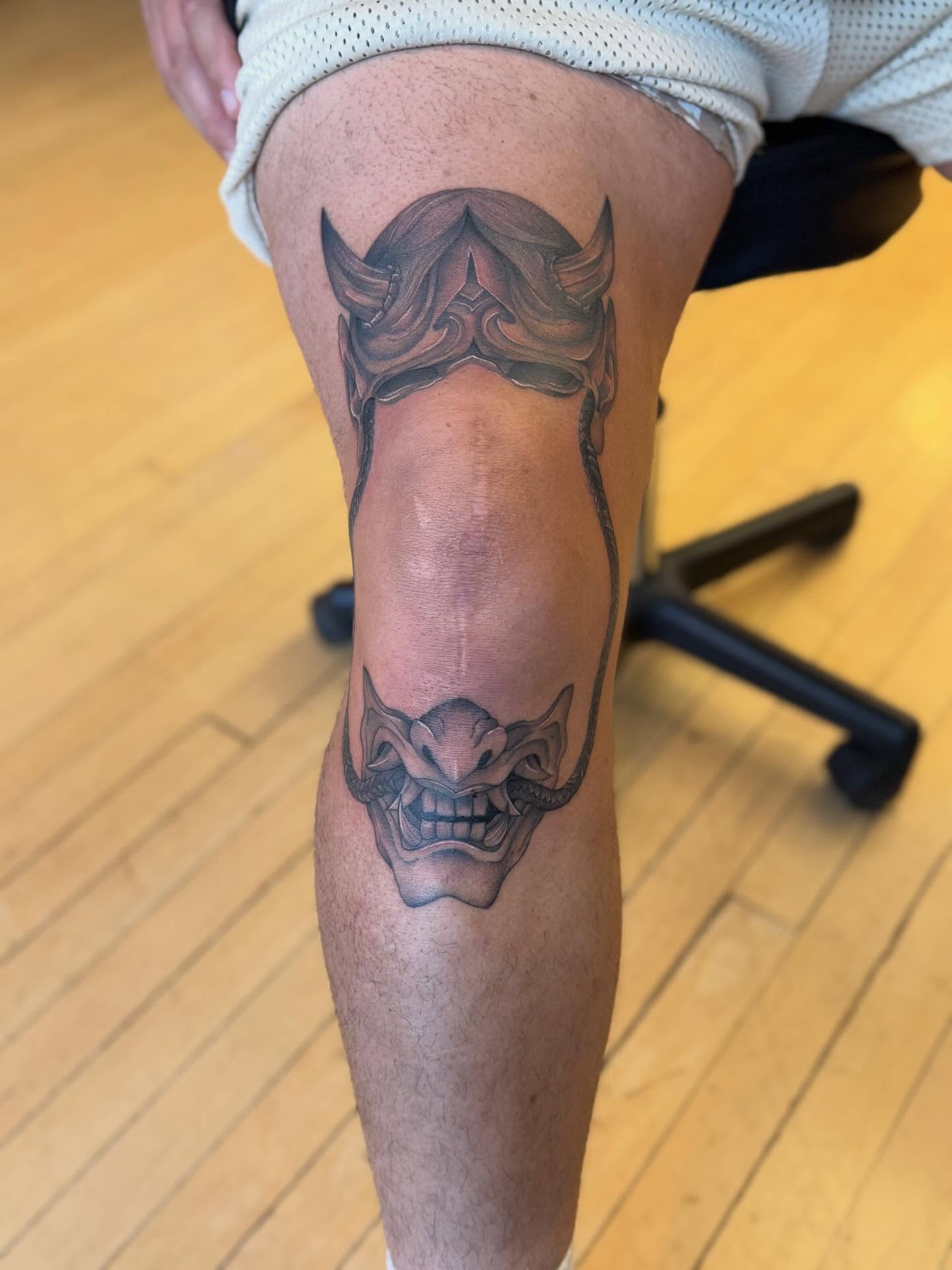 Mask black and grey tattoo on the thigh by Dre