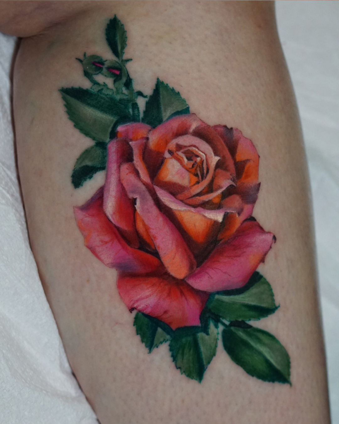 Rose realism tattoo on the thigh by San Diego Color Realism and Neotraditional