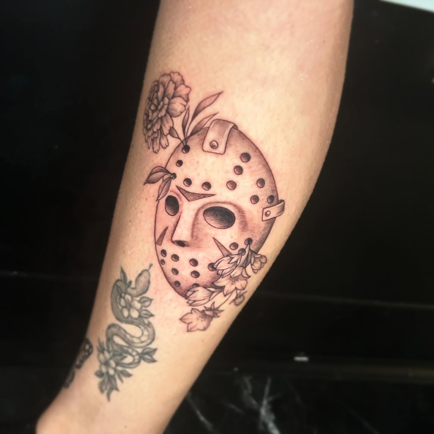 Mask and flowers American traditional tattoo on the forearm by 🕸🖤Kass🖤🕸