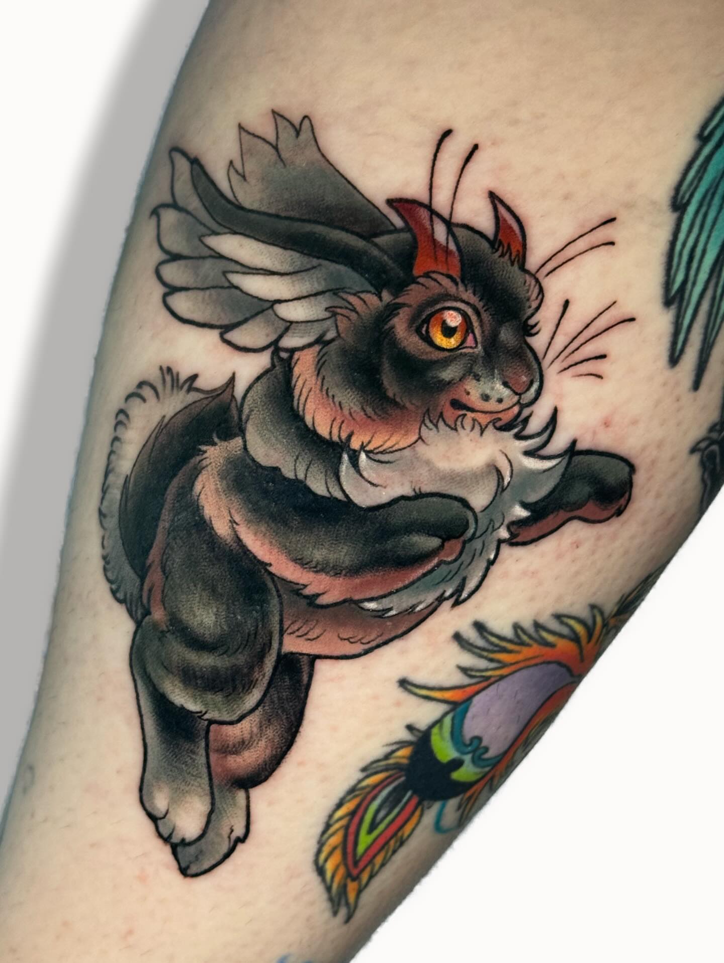 Flying cat American traditional tattoo on the forearm by Ash Sansoucie
