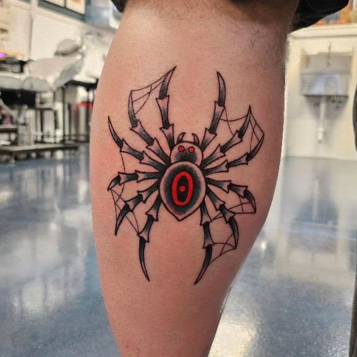 Spider geometric tattoo on the thigh by Matt Page