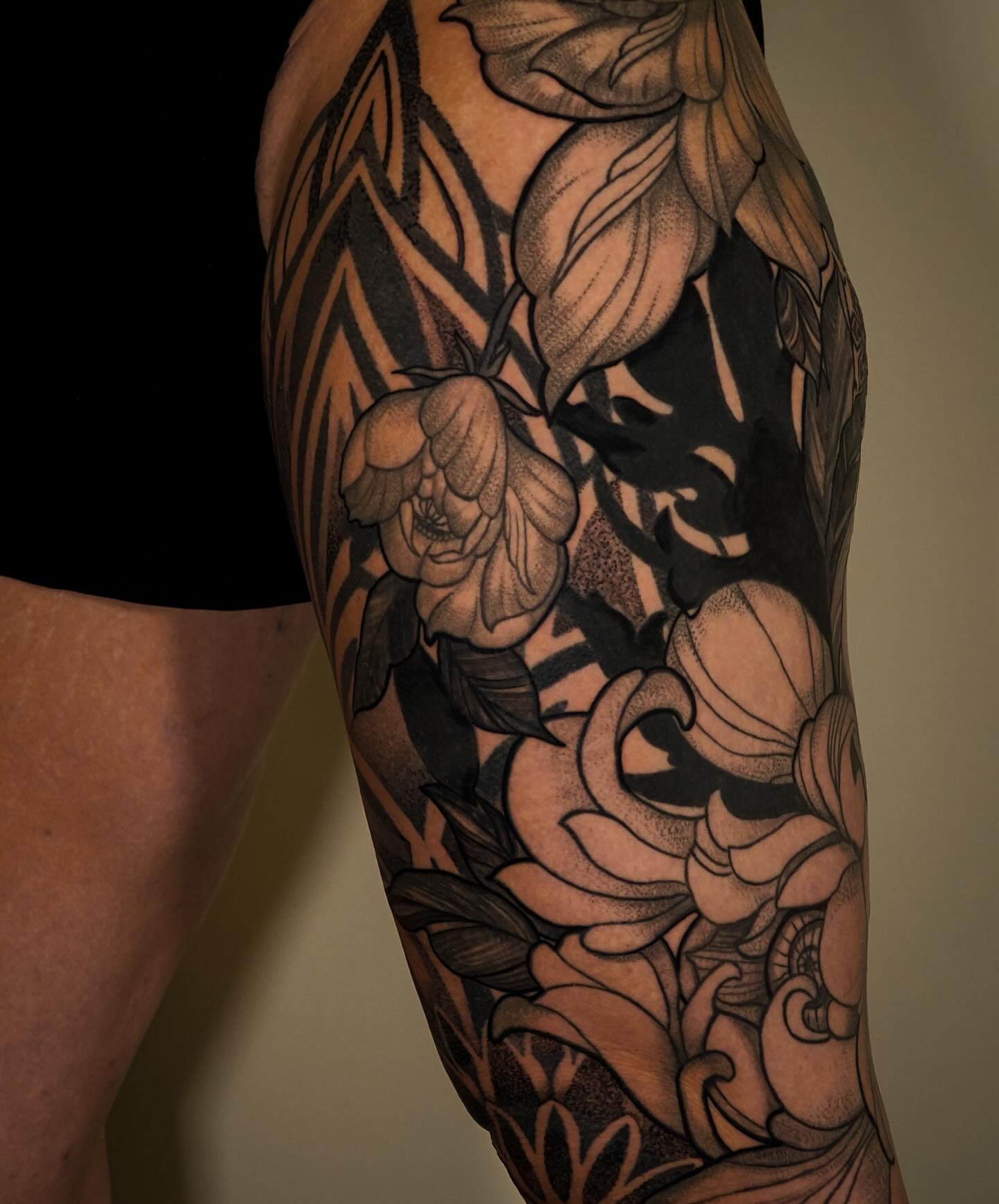 Floral bouquet black and grey tattoo on the forearm by Katherin Plaza