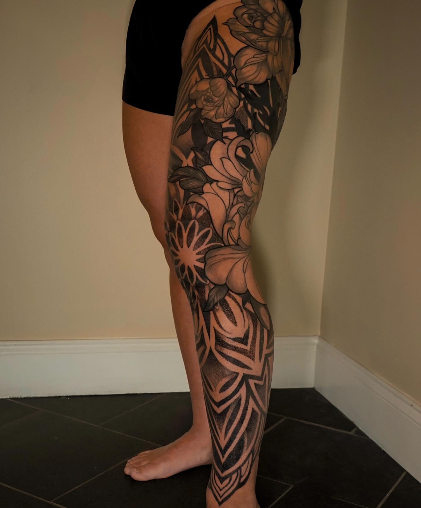 Floral design black and grey tattoo on the calf by Katherin Plaza