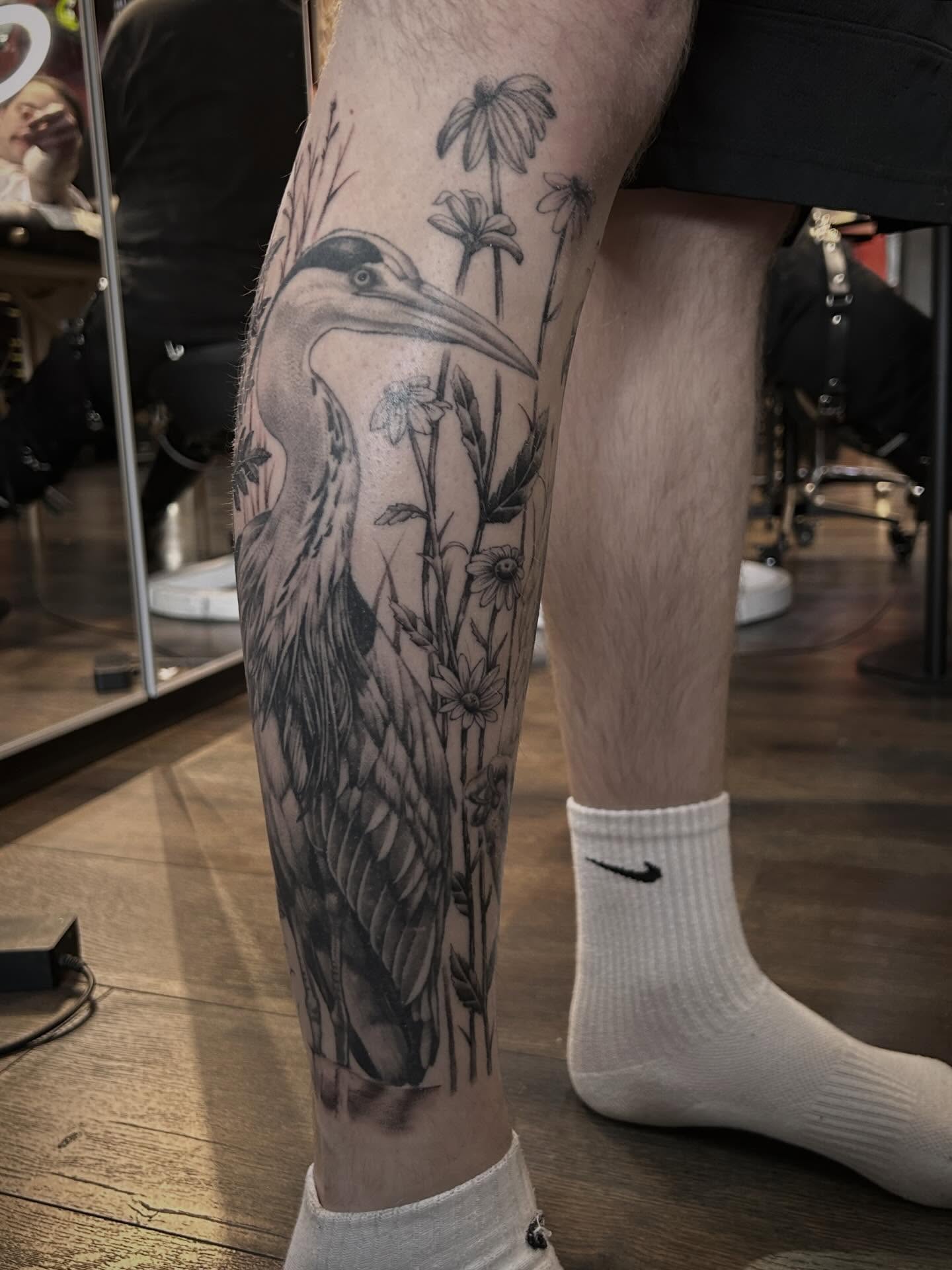 Heron and flowers realism tattoo on the calf by Tako, Seattle, Washington