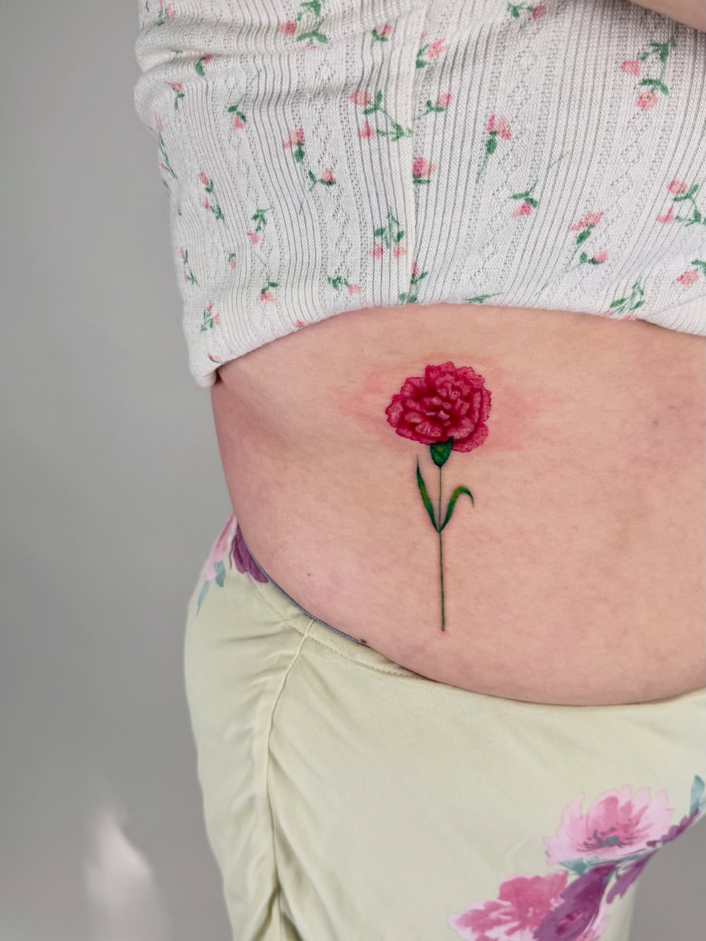 Peony realism tattoo on the torso by sabina