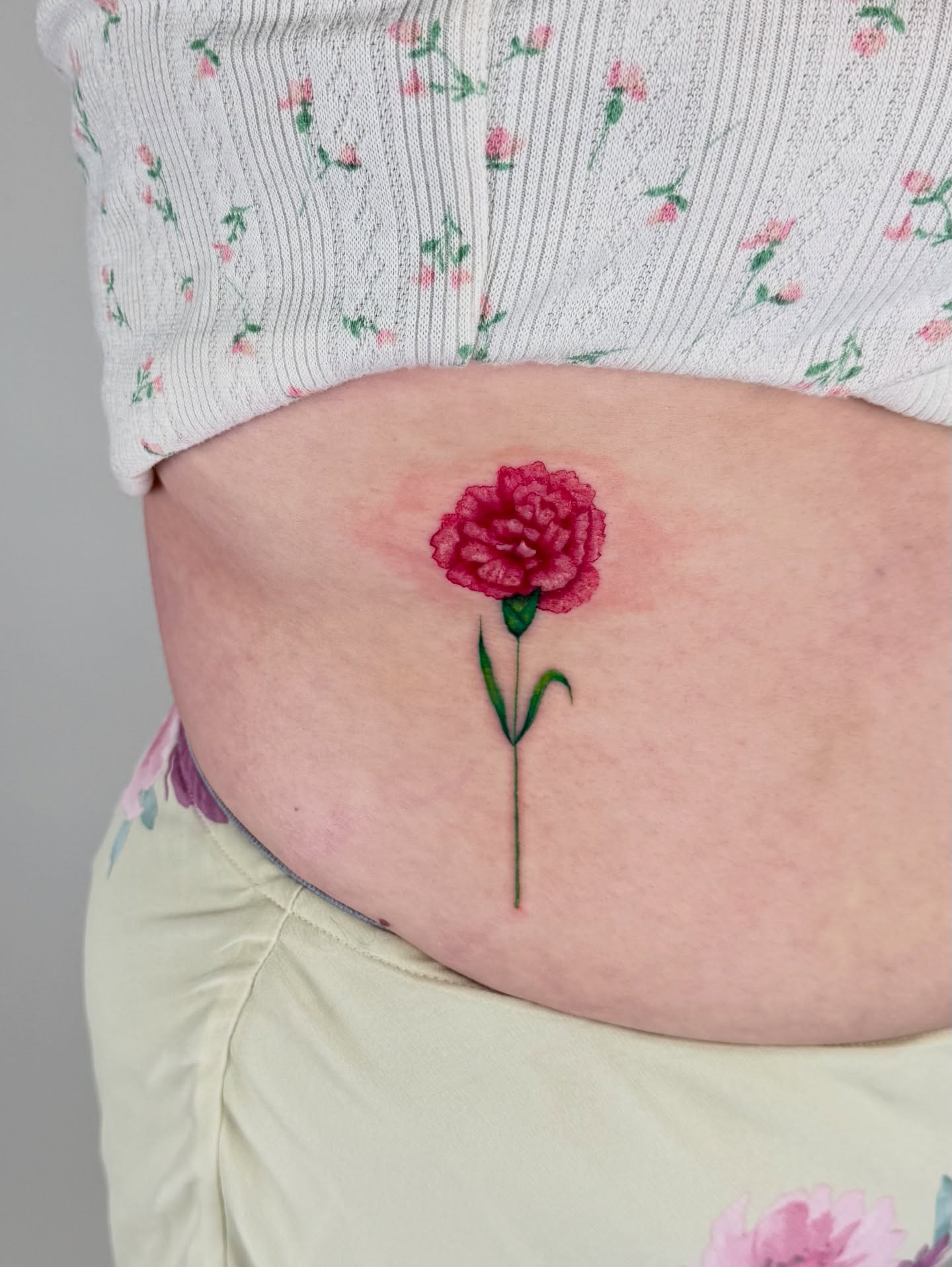 Peony watercolor tattoo on the torso by sabina
