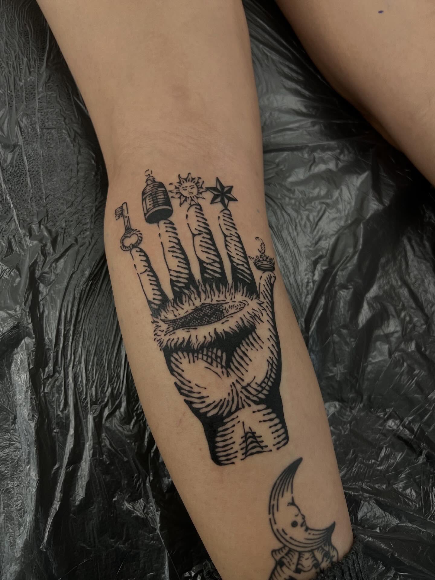 Hand with symbols black and grey tattoo on the forearm by Wonny
