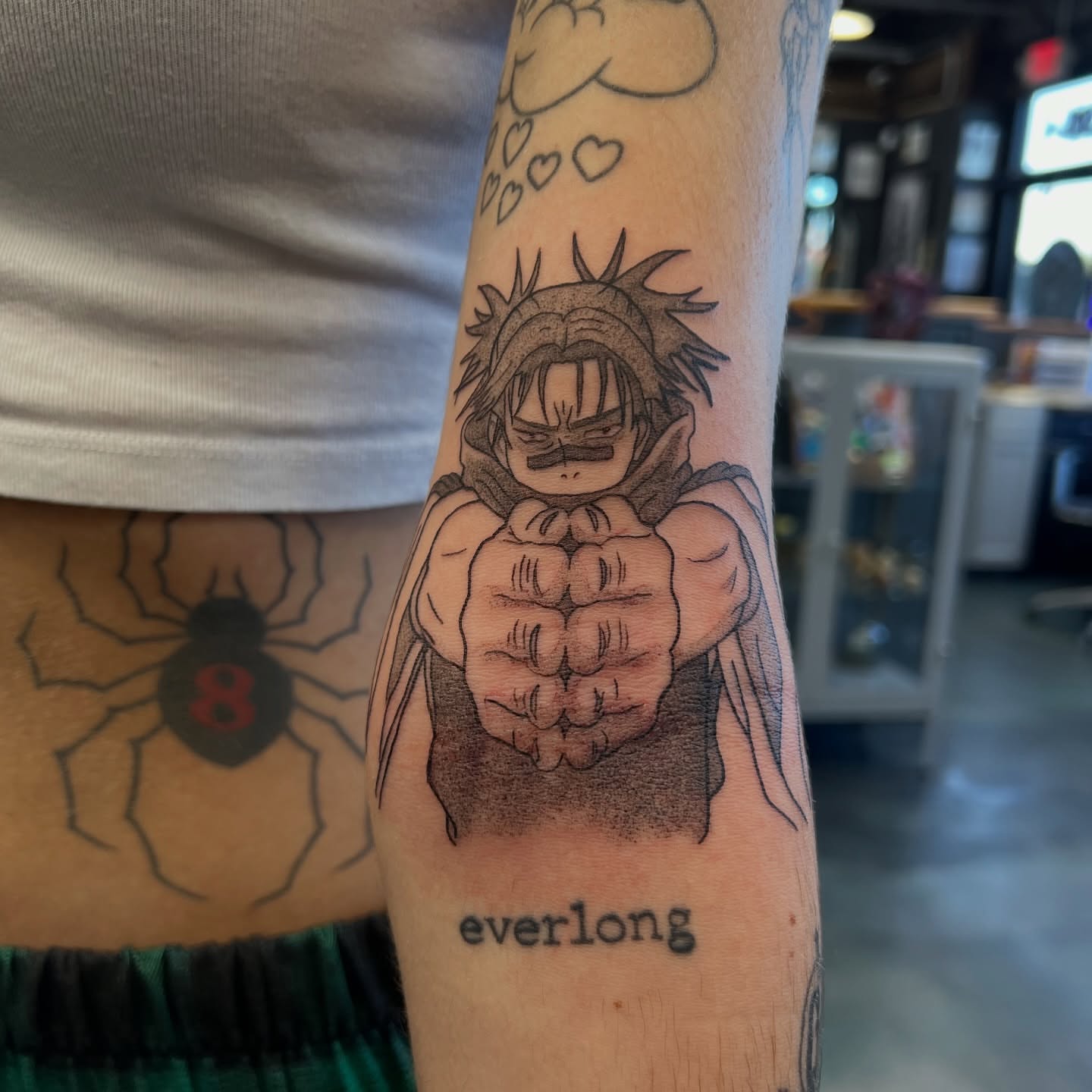 Muscular character dotwork tattoo on the forearm by Leslie Paskoff