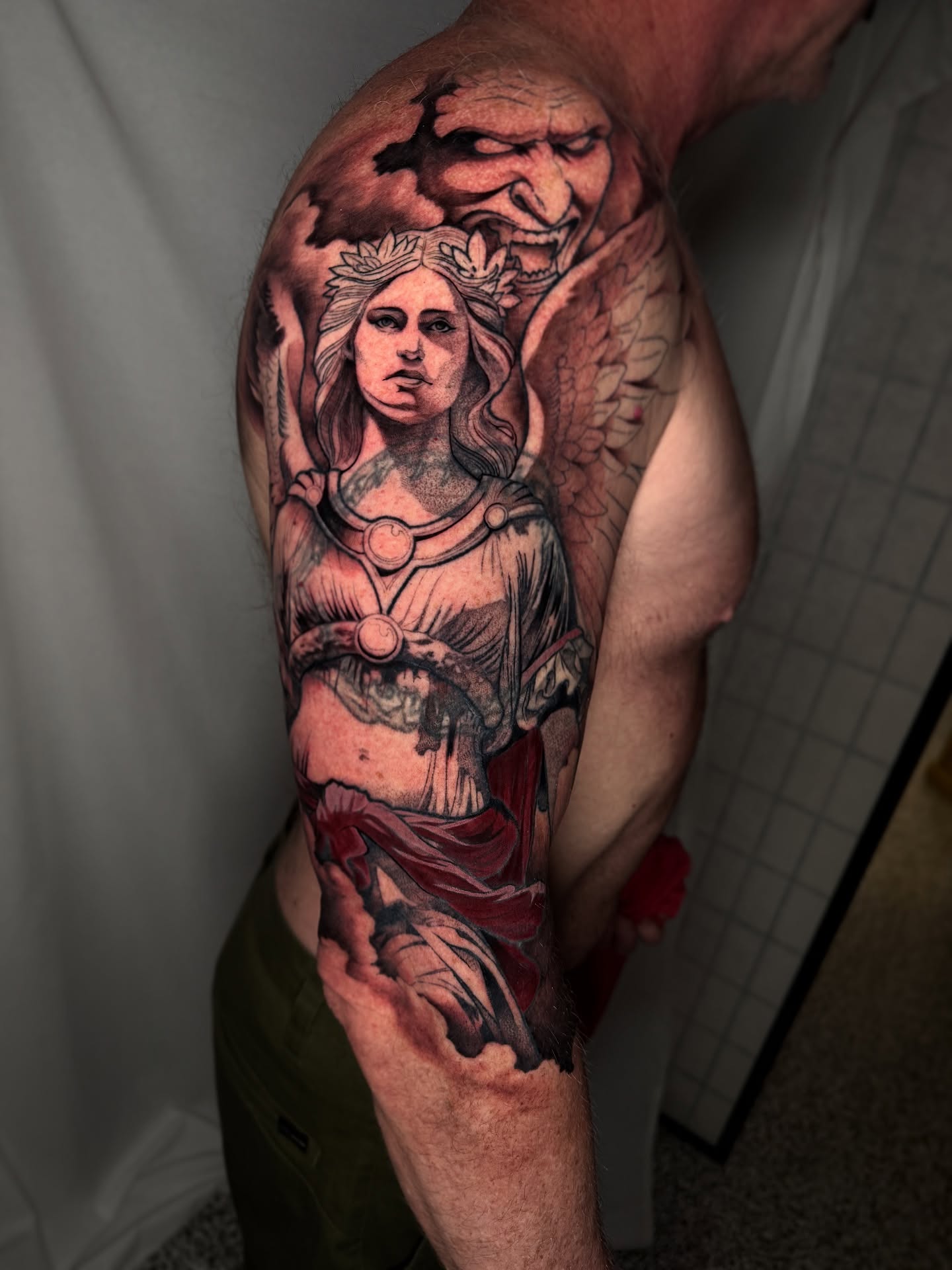 Angelic figure realism tattoo on the upper arm by Neotrav Tattoos
