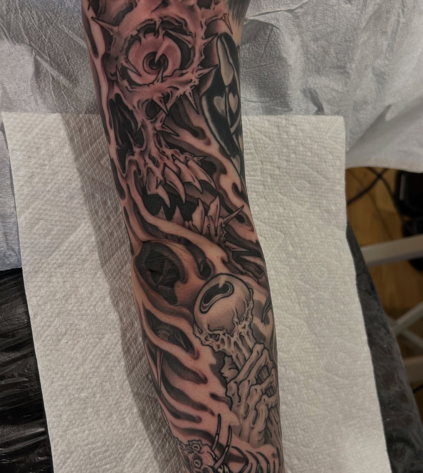Skull and flames dark realism tattoo on the forearm by Craig Gardyan
