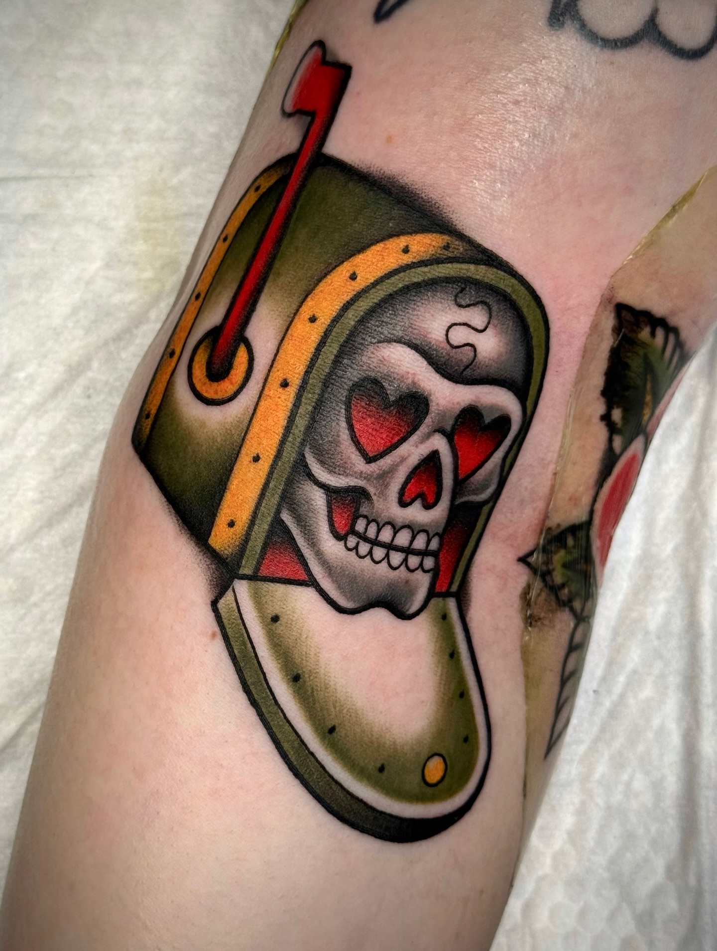 Skull with heart eyes American traditional tattoo on the forearm by Black and color tattoo!