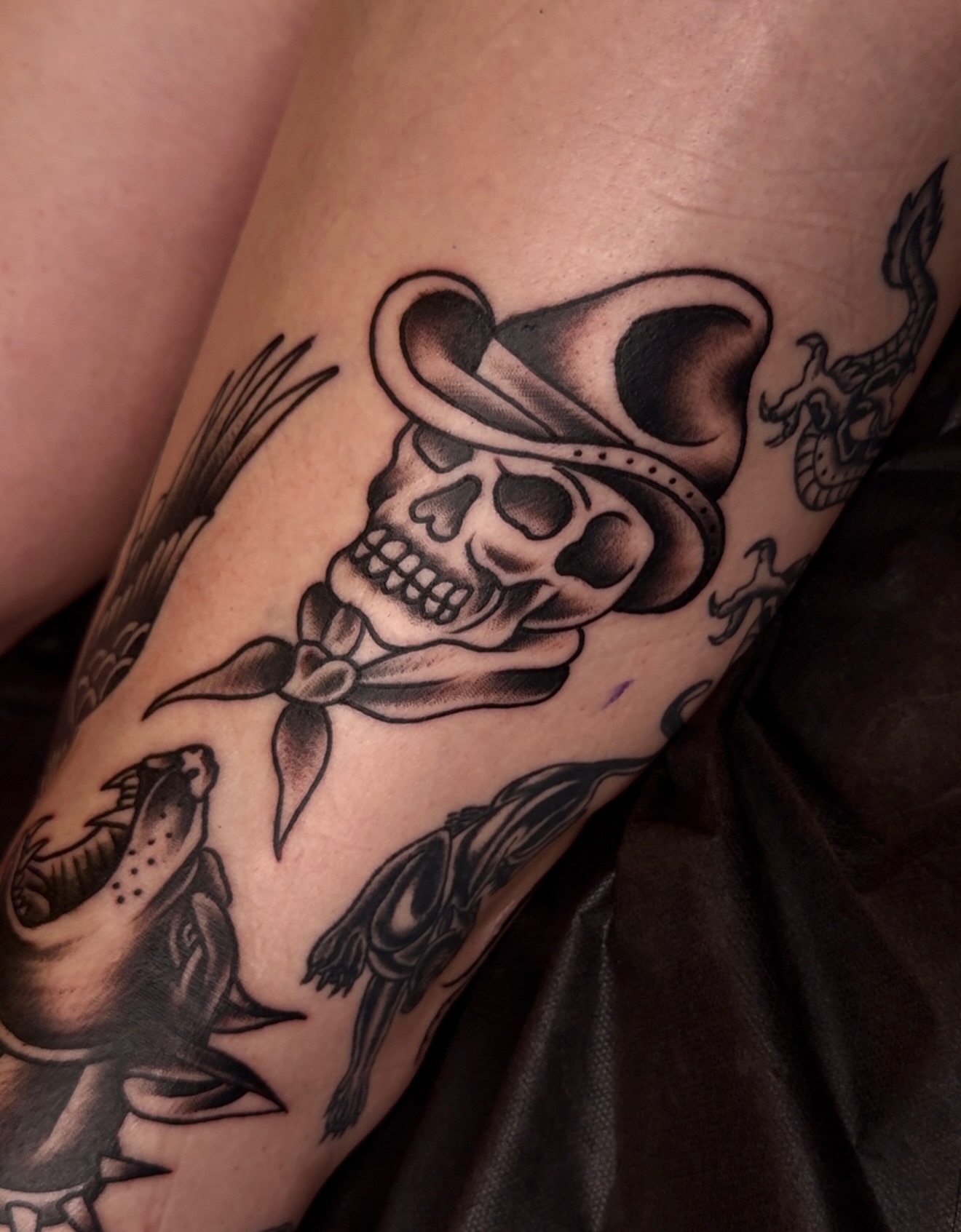Skull wearing hat American traditional tattoo on the forearm by E