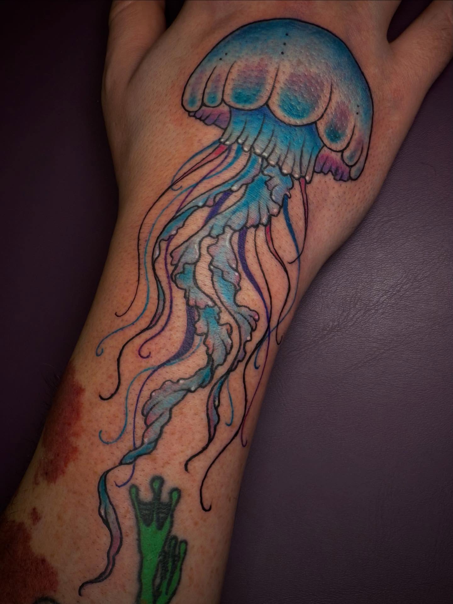 Jellyfish watercolor tattoo on the forearm by Eden H., Columbus, Ohio